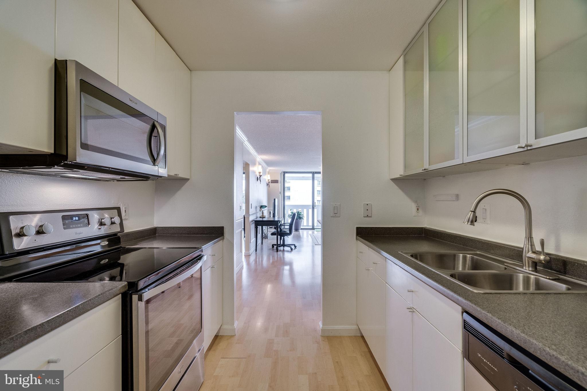 6101 Edsall Road, Unit 905 Alexandria, VA 22304 - Photo 24 of 62 a kitchen with stainless steel appliances granite countertop a sink stove and cabinets
