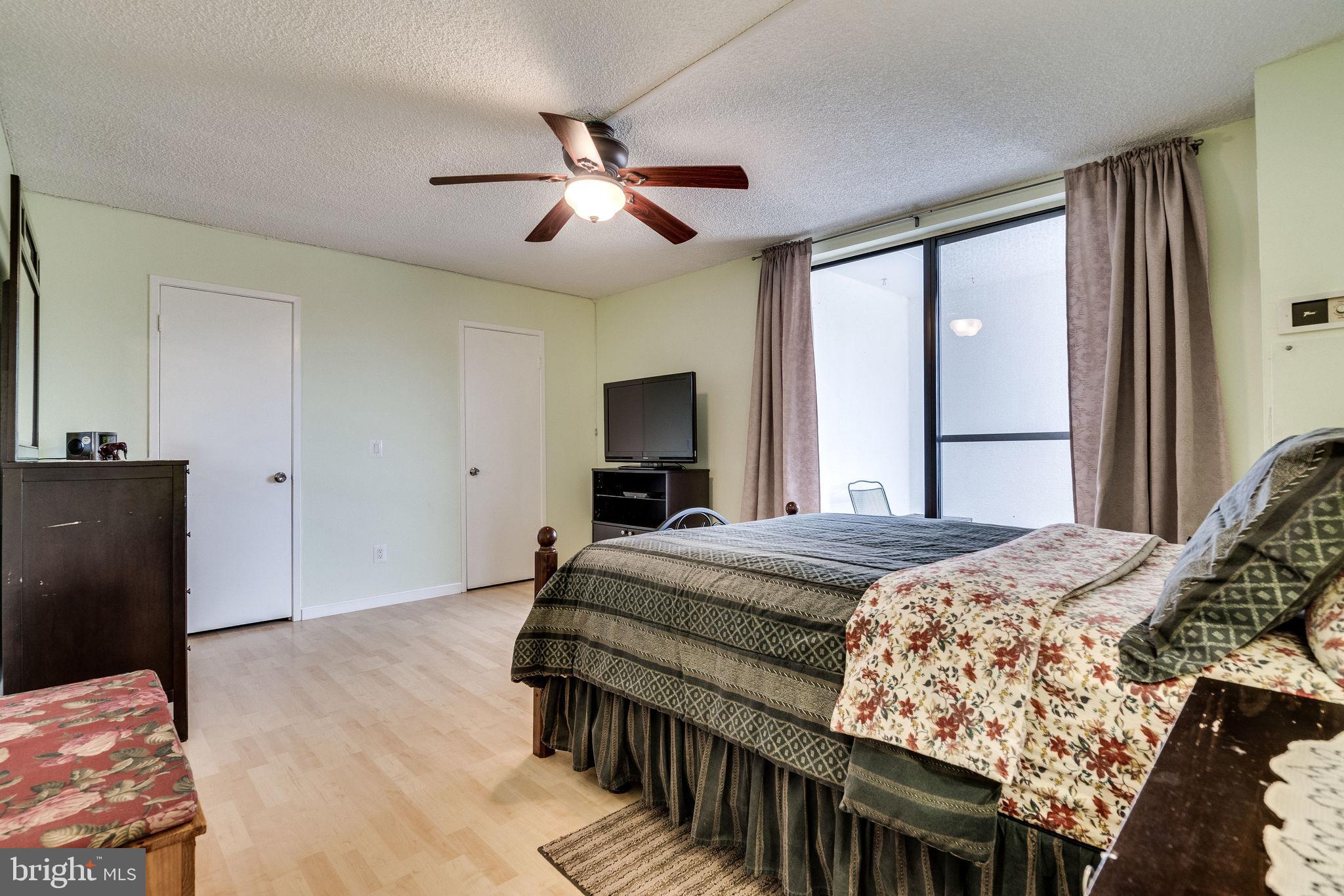 6101 Edsall Road, Unit 905 Alexandria, VA 22304 - Photo 27 of 62 a bedroom with a bed and wooden floor