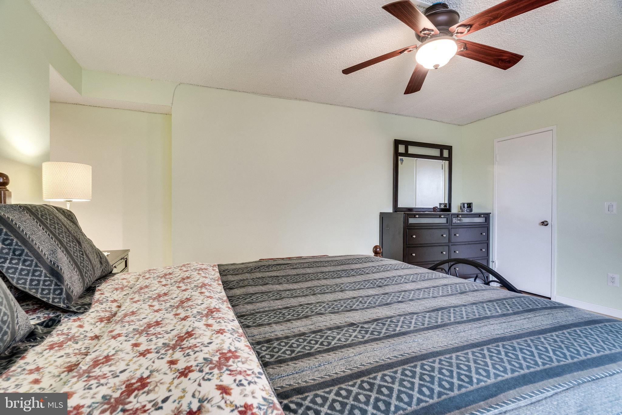 6101 Edsall Road, Unit 905 Alexandria, VA 22304 - Photo 29 of 62 a bedroom with a bed and a chandelier