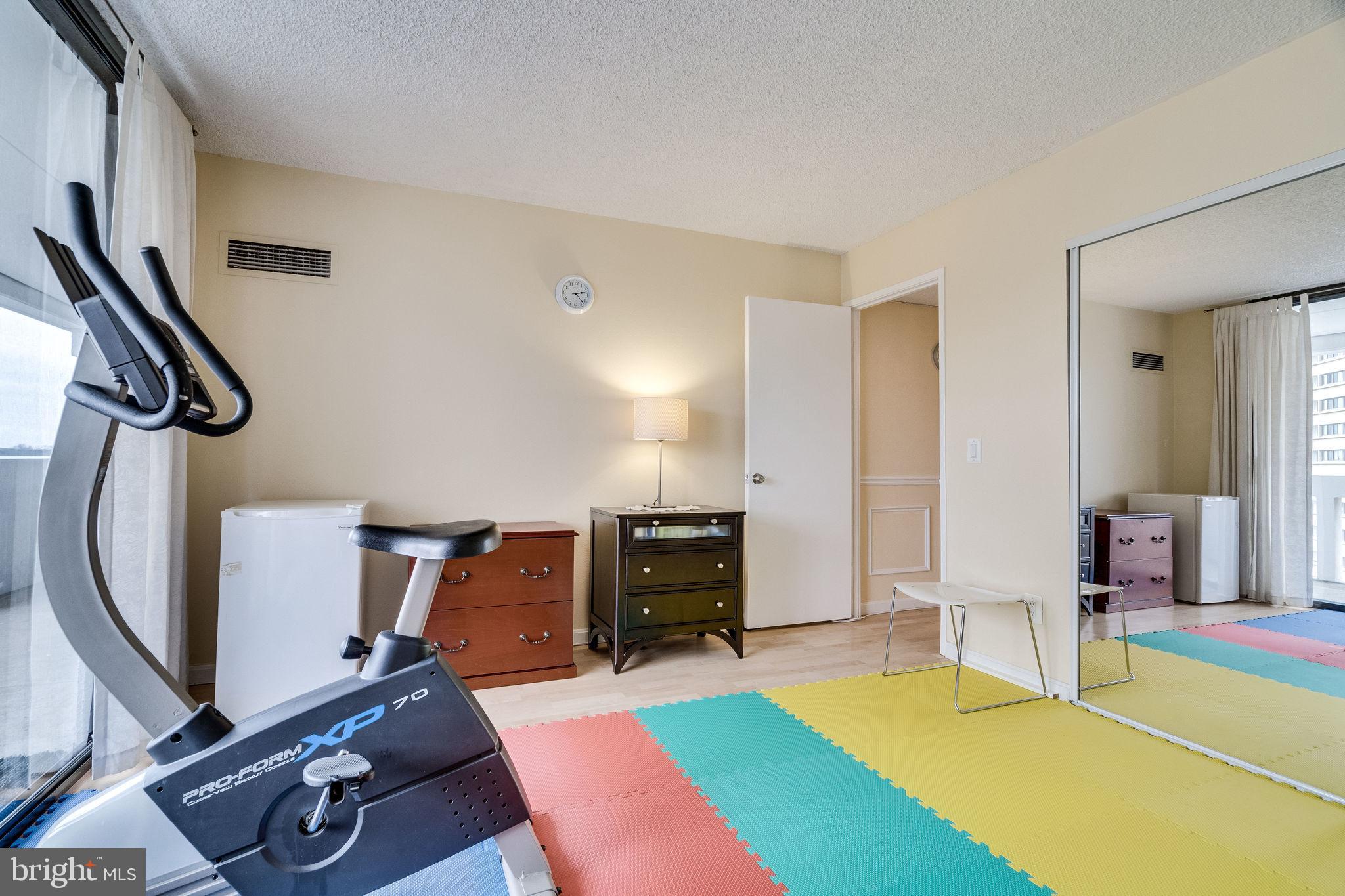 6101 Edsall Road, Unit 905 Alexandria, VA 22304 - Photo 36 of 62 a living room with furniture gym equipment and a view of living room