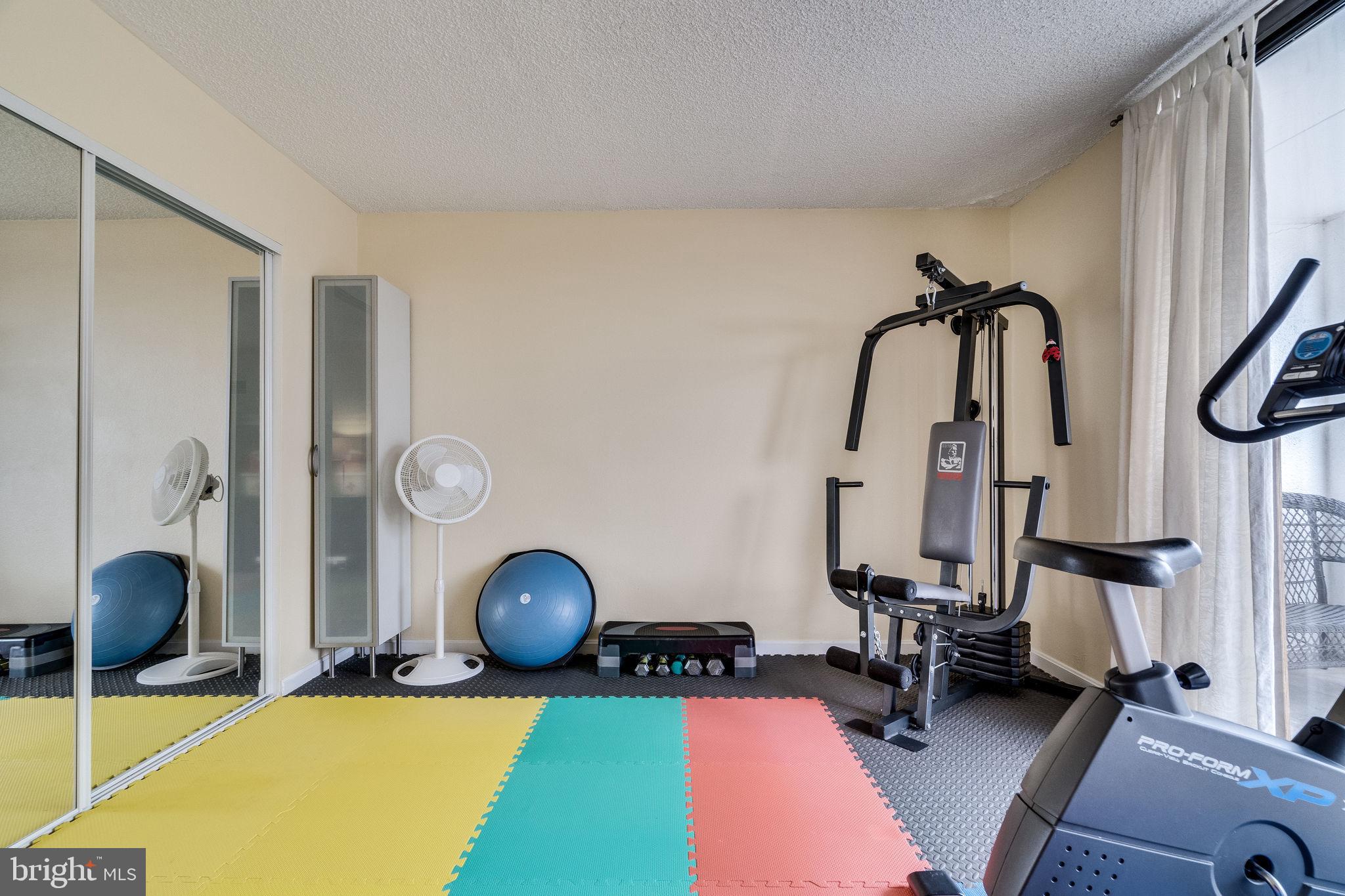 6101 Edsall Road, Unit 905 Alexandria, VA 22304 - Photo 38 of 62 a room with gym equipment and glass door
