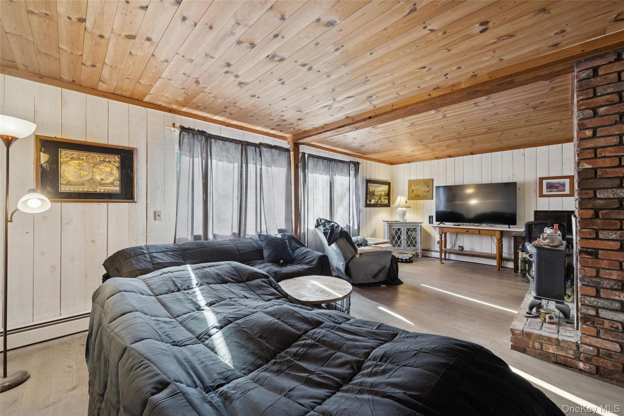 1363 Brick Kiln Road Sag Harbor, NY 11963 - Photo 2 of 13 a living room with furniture and a flat screen tv
