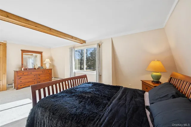 a bedroom with bed and a window with outer view