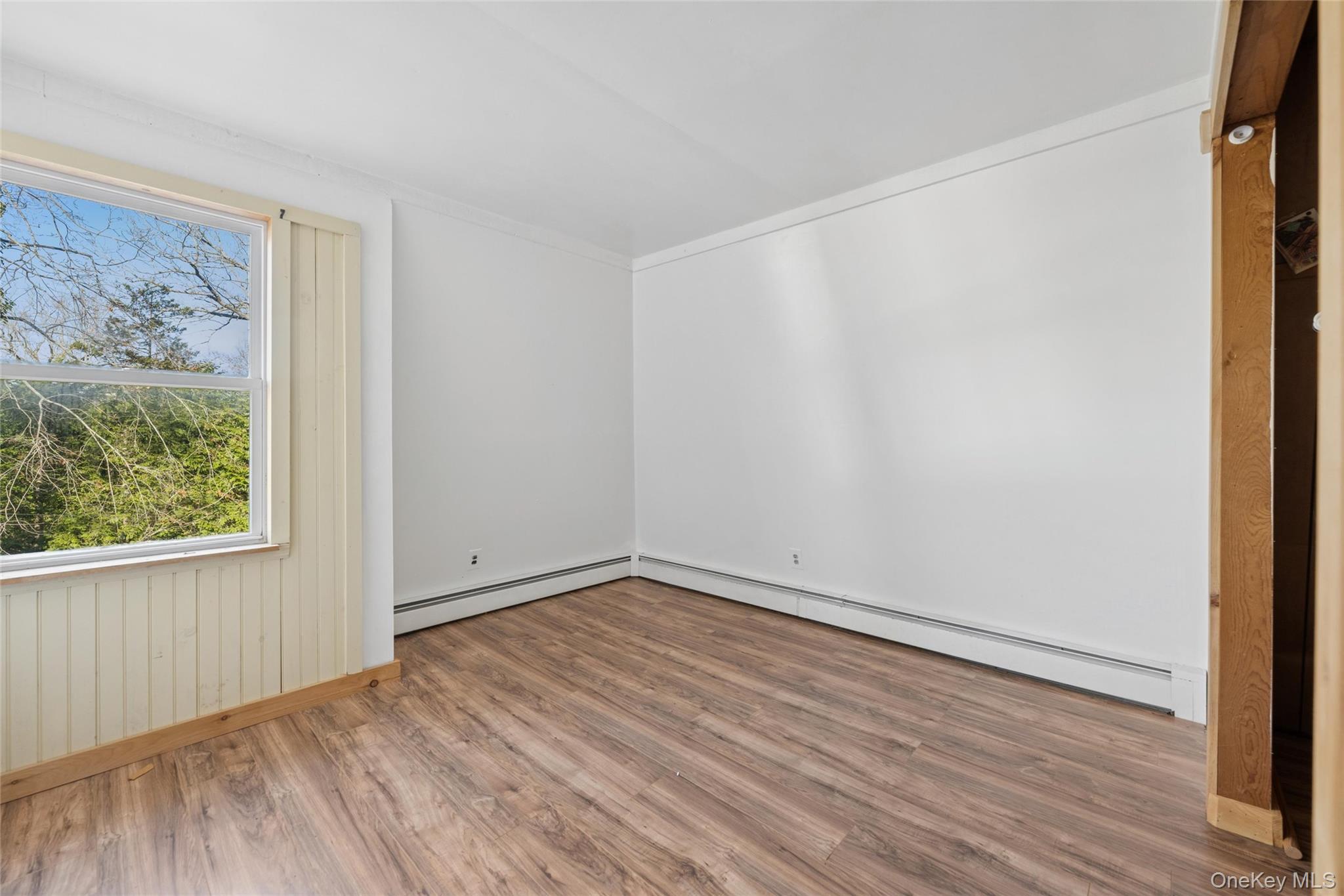 1363 Brick Kiln Road Sag Harbor, NY 11963 - Photo 9 of 13 a view of an empty room with wooden floor and a window