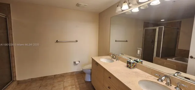 a bathroom with a granite countertop sink mirror and double