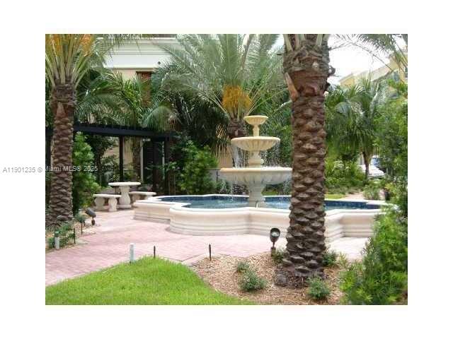 888 Douglas Road, Unit 601 Miami, FL 33134 - Photo 4 of 11 a view of a house with backyard porch and garden