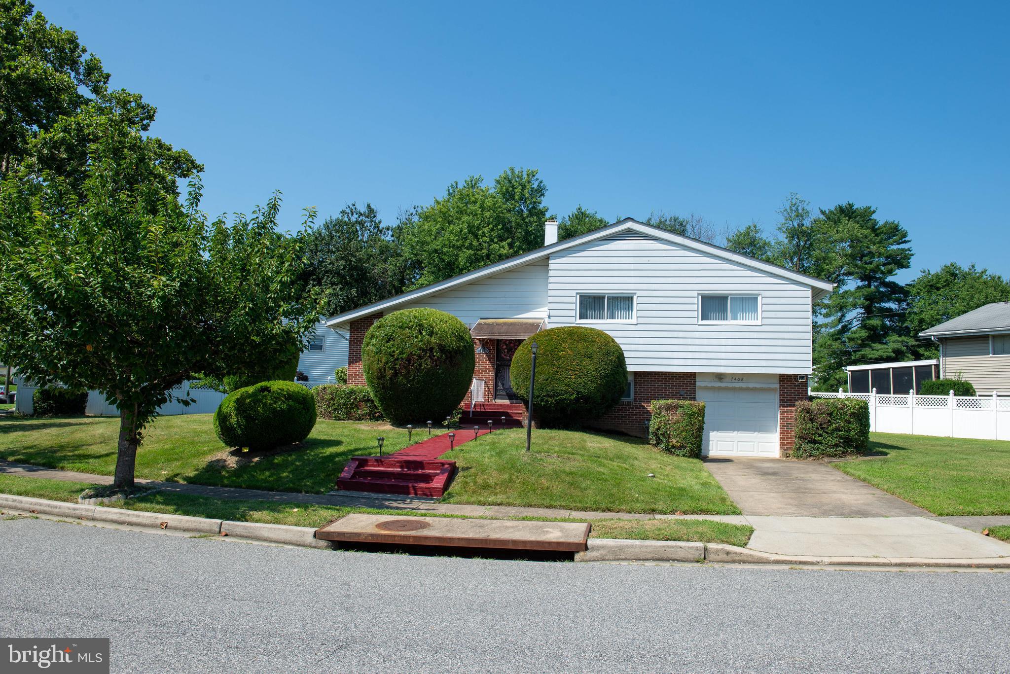 7408 Shirley Road Baltimore, MD 21207 - Photo 1 of 25 a front view of a house with garden