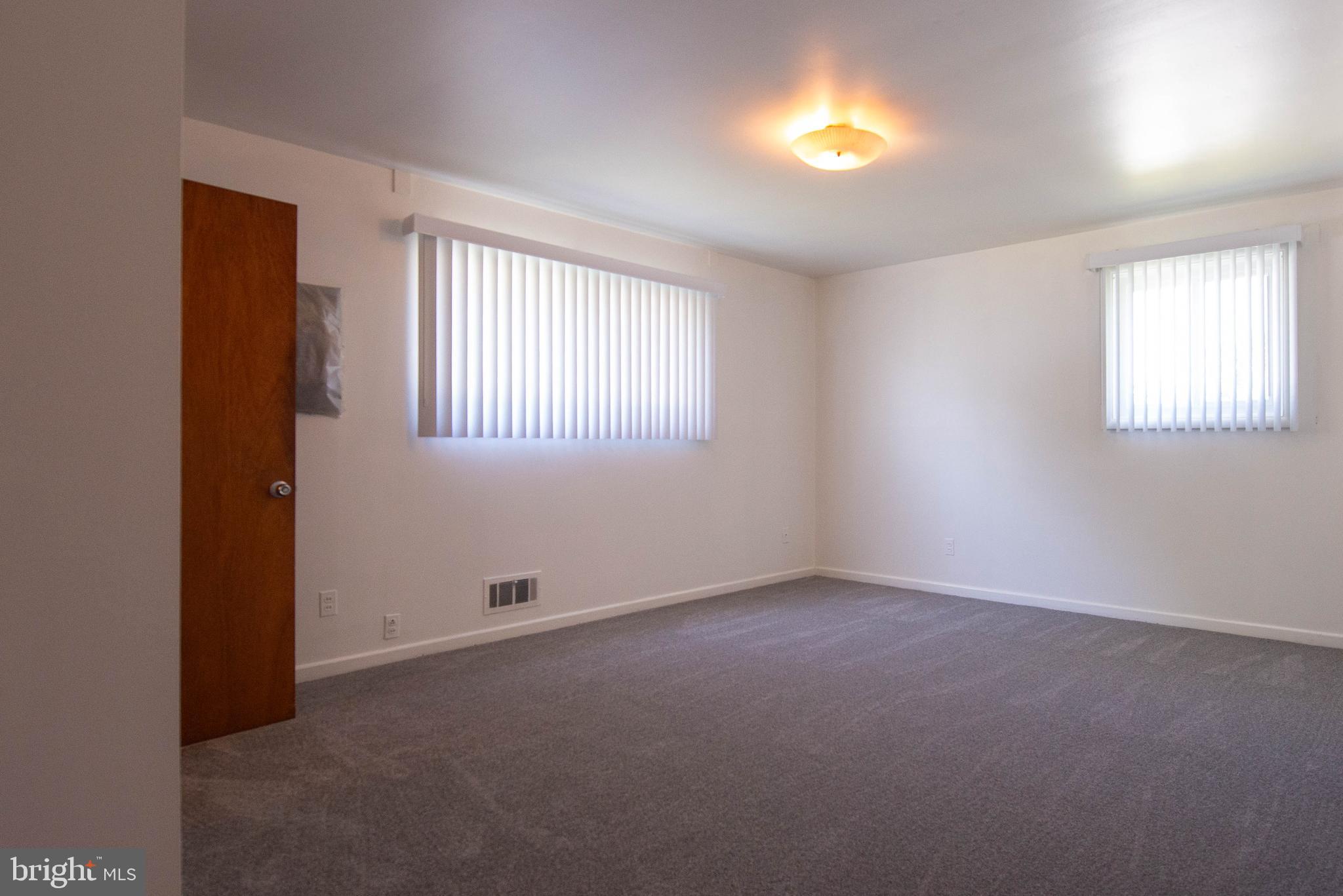 7408 Shirley Road Baltimore, MD 21207 - Photo 12 of 25 an empty room with window and windows