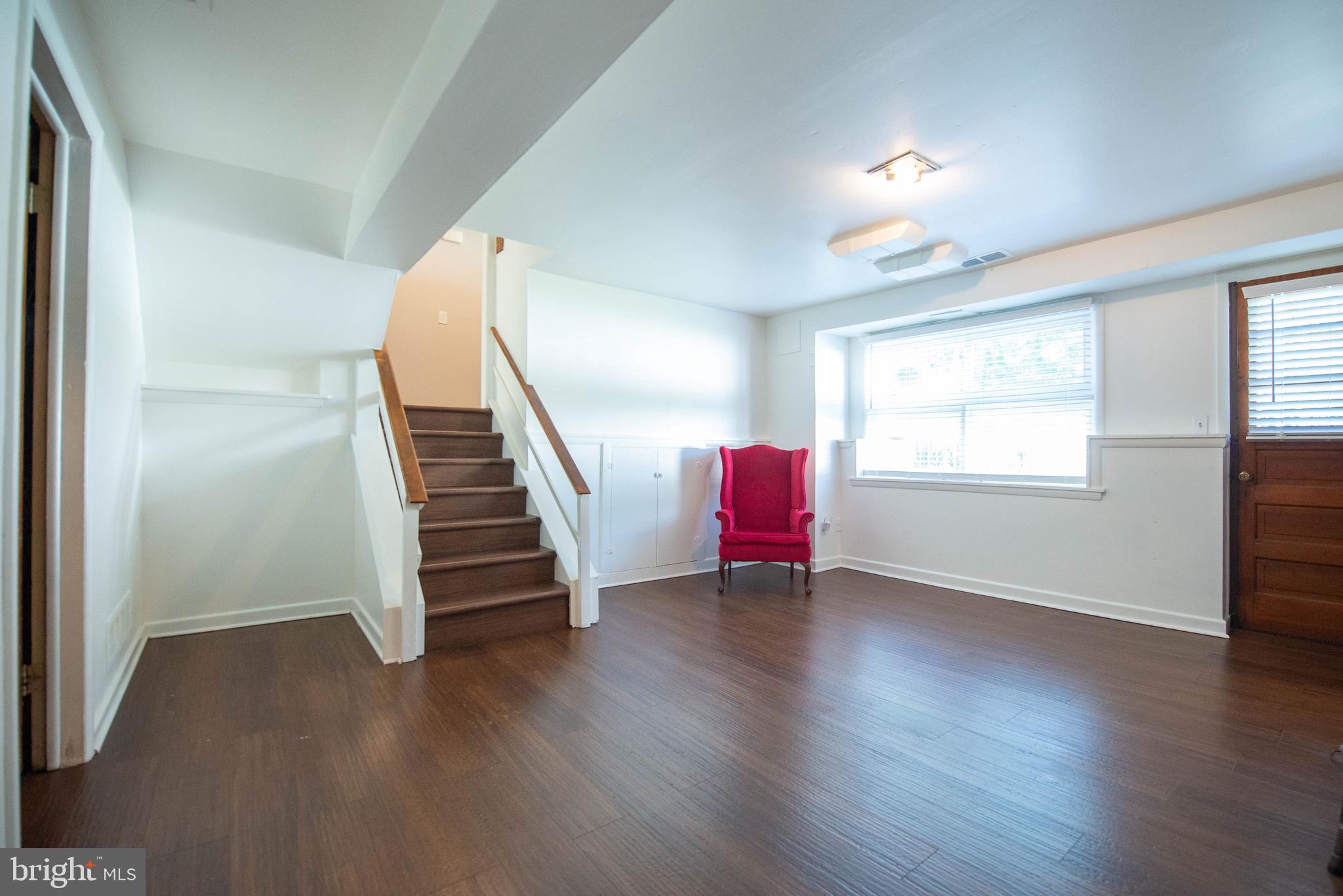 7408 Shirley Road Baltimore, MD 21207 - Photo 13 of 25 a view of a livingroom with wooden floor and stairs