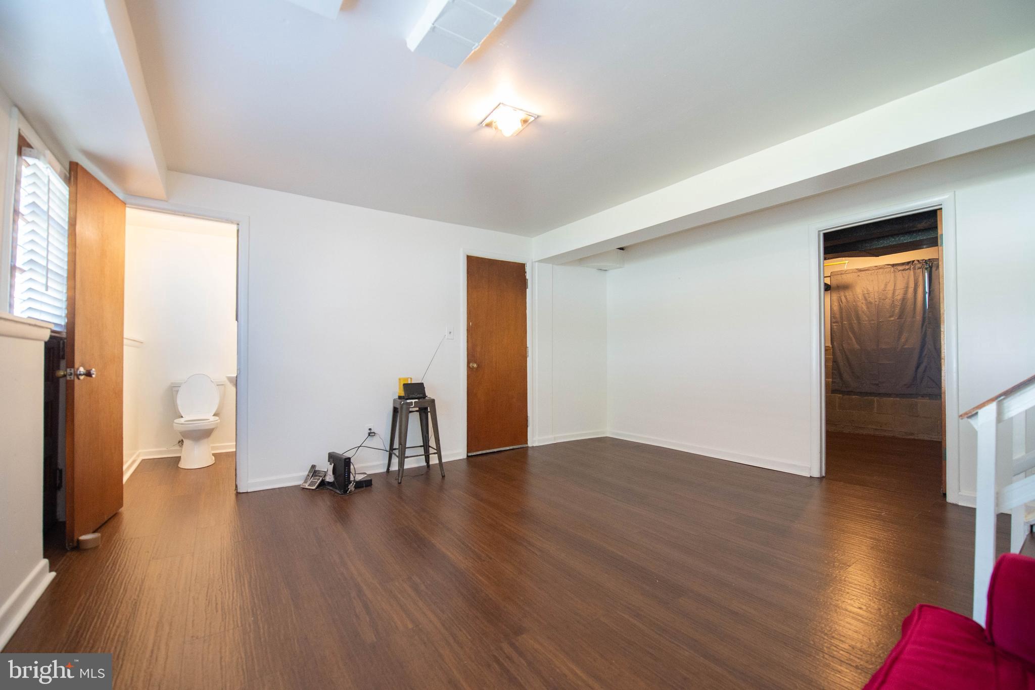 7408 Shirley Road Baltimore, MD 21207 - Photo 14 of 25 a view of empty room with wooden floor