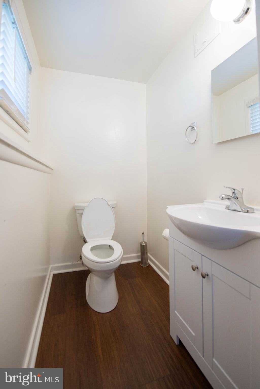 7408 Shirley Road Baltimore, MD 21207 - Photo 15 of 25 a bathroom with a sink toilet and a mirror