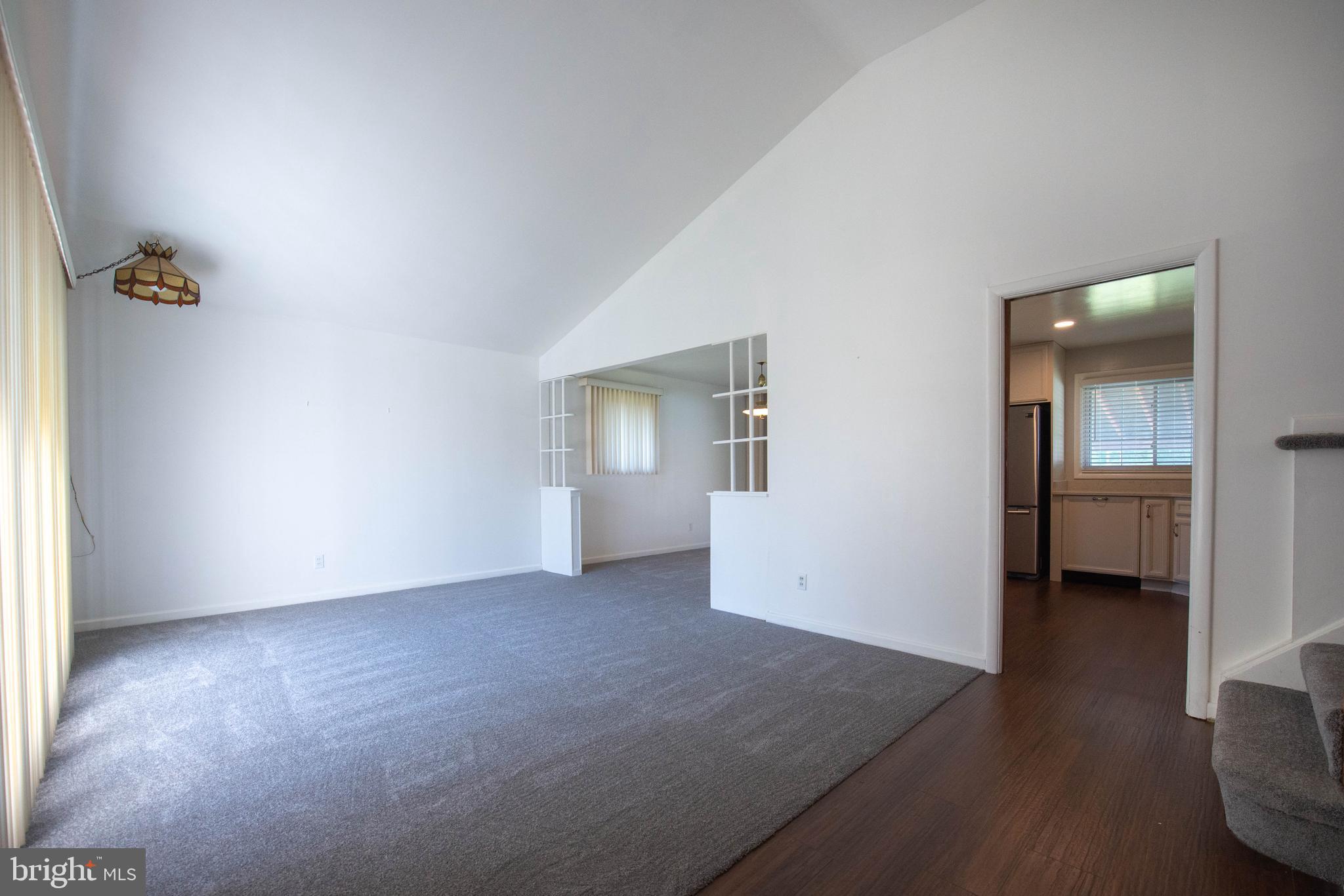 7408 Shirley Road Baltimore, MD 21207 - Photo 5 of 25 an empty room with wooden floor and windows