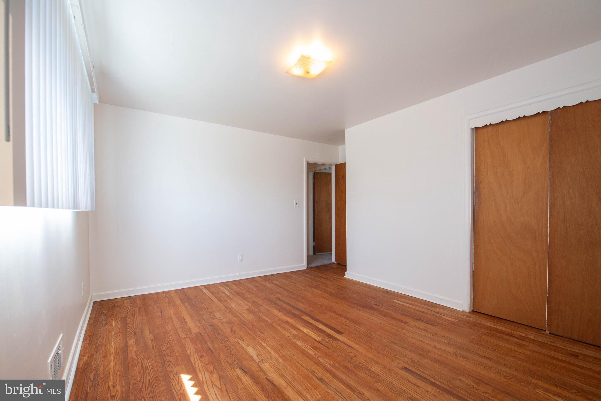 7408 Shirley Road Baltimore, MD 21207 - Photo 8 of 25 a view of empty room with wooden floor