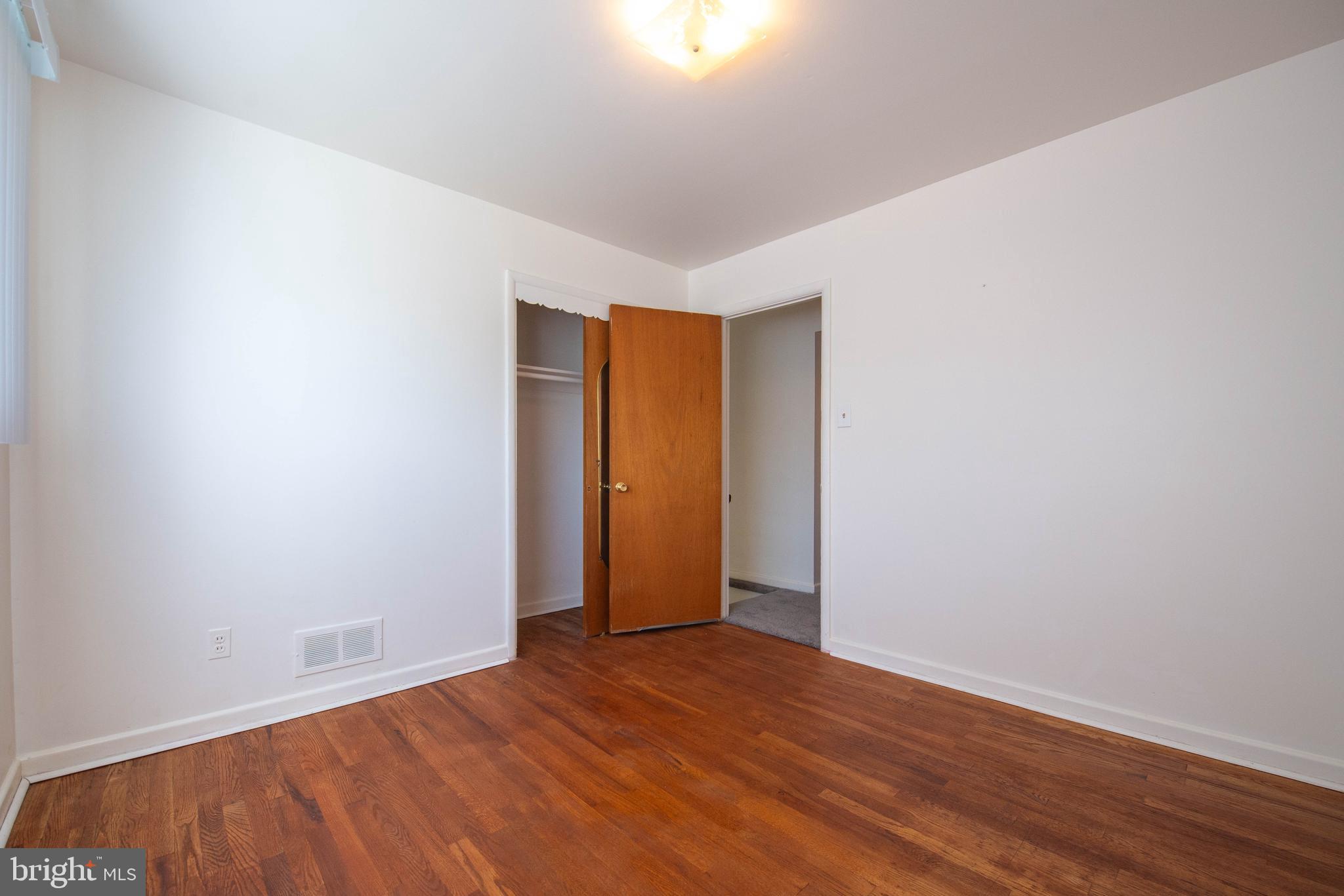 7408 Shirley Road Baltimore, MD 21207 - Photo 10 of 25 a view of an empty room with wooden floor