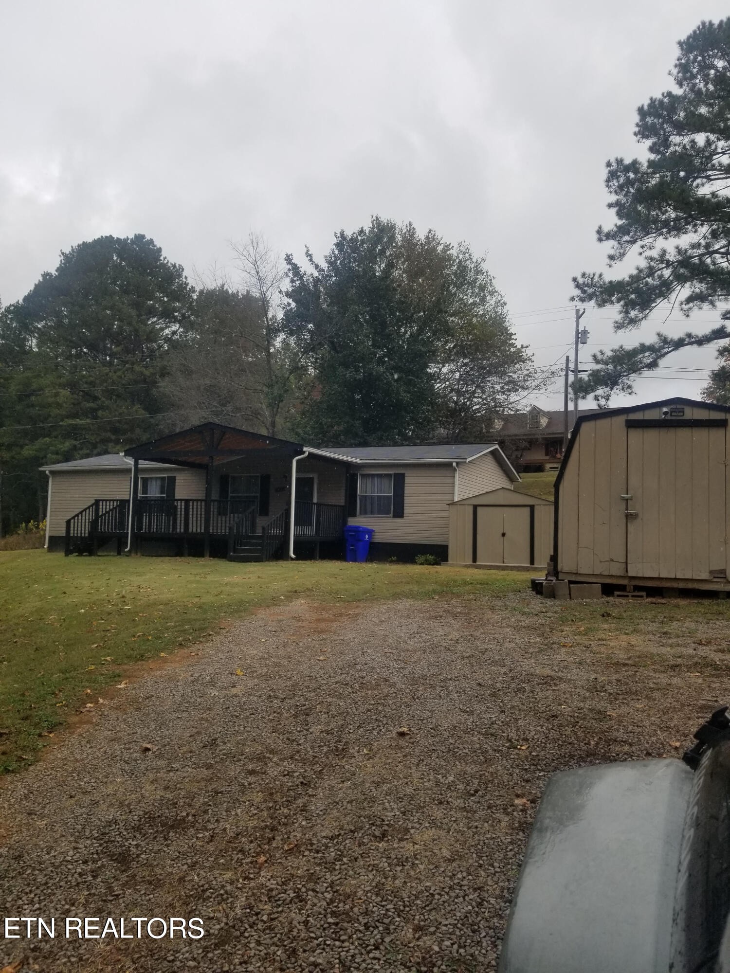 a front view of a house with a yard and trees