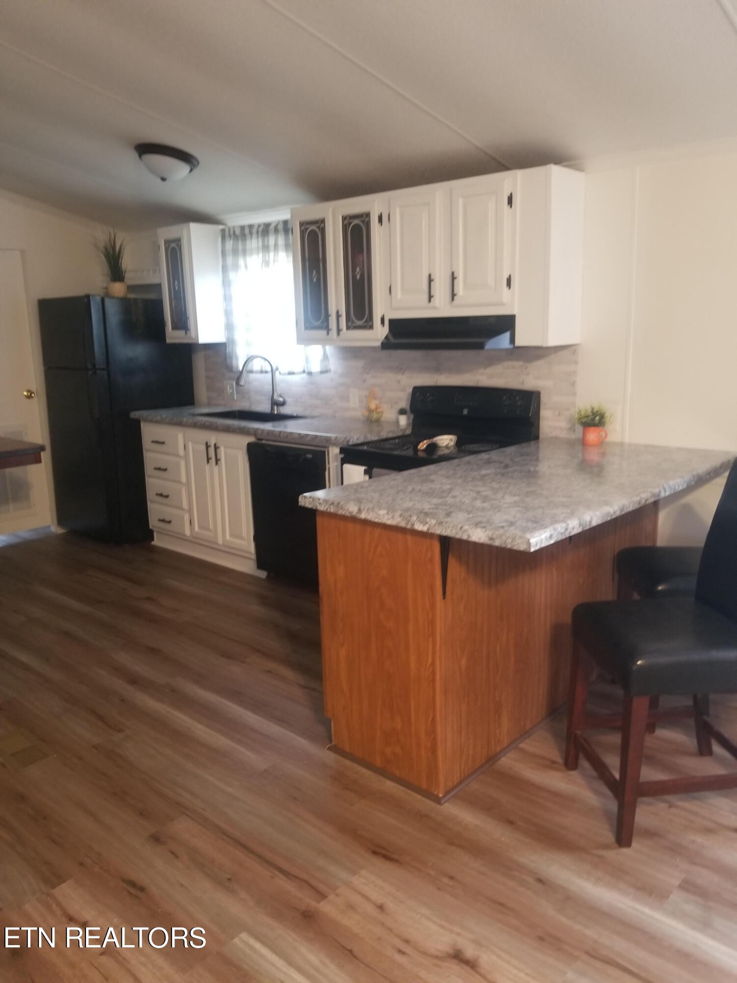 345 Fiske Road Harriman, TN 37748 - Photo 5 of 12 a kitchen with stainless steel appliances granite countertop a stove a sink dishwasher and a refrigerator with wooden floor