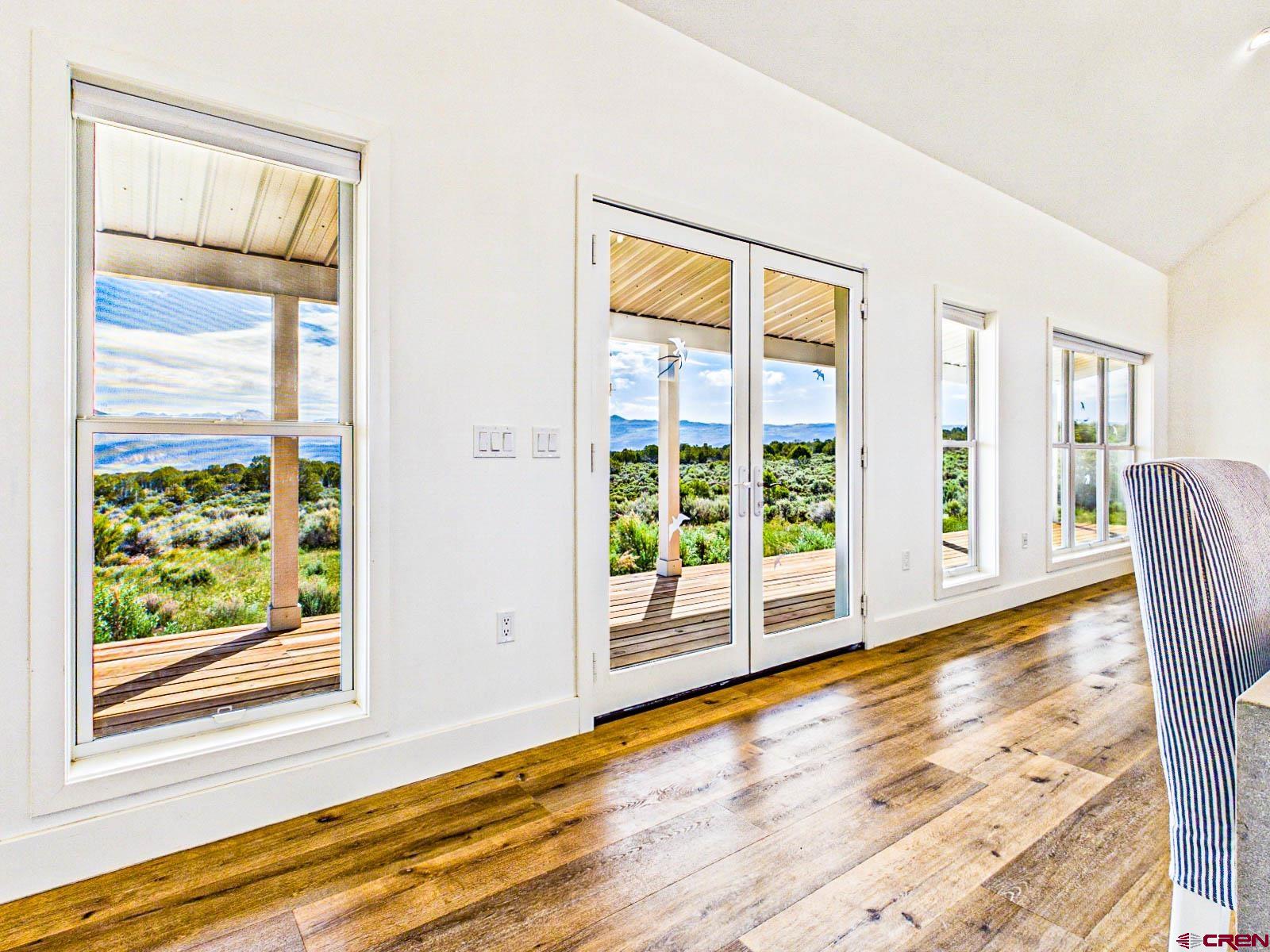 3530 Black Canyon Road Crawford, CO 81415 - Photo 11 of 45 a view of an empty room with wooden floor and a window