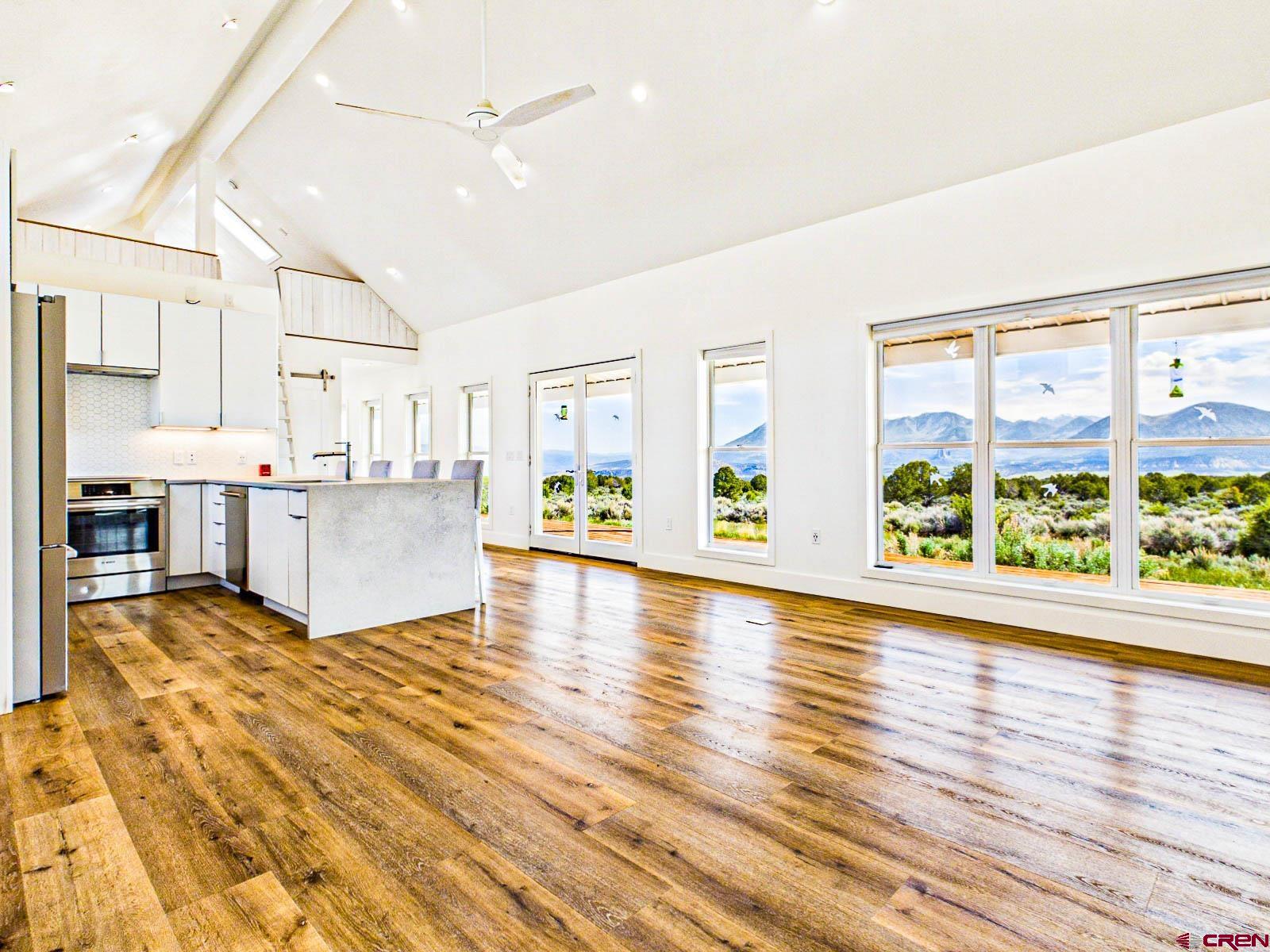 3530 Black Canyon Road Crawford, CO 81415 - Photo 14 of 45 a view of open kitchen with furniture and wooden floor