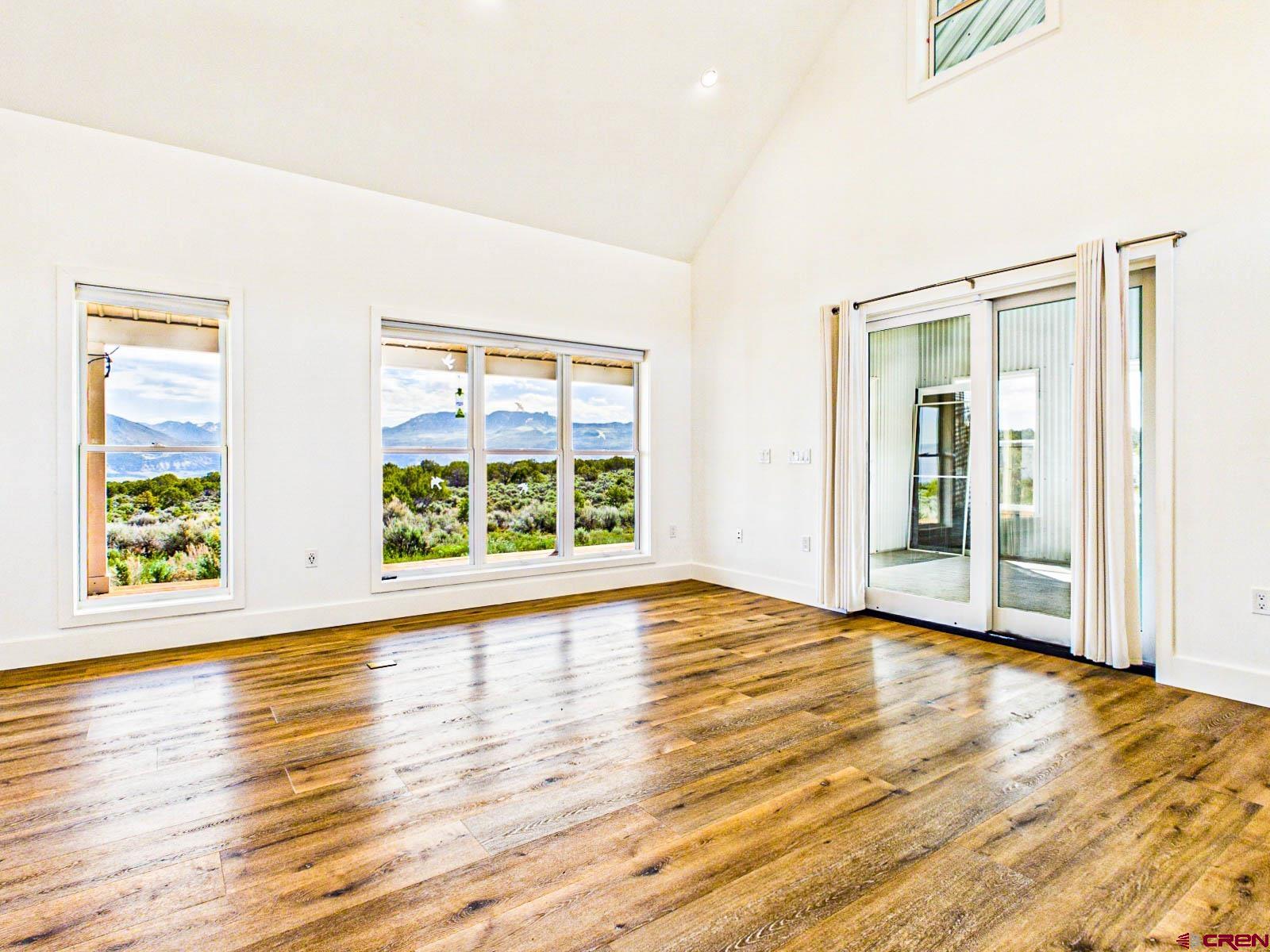 3530 Black Canyon Road Crawford, CO 81415 - Photo 15 of 45 a view of an empty room with wooden floor and a window