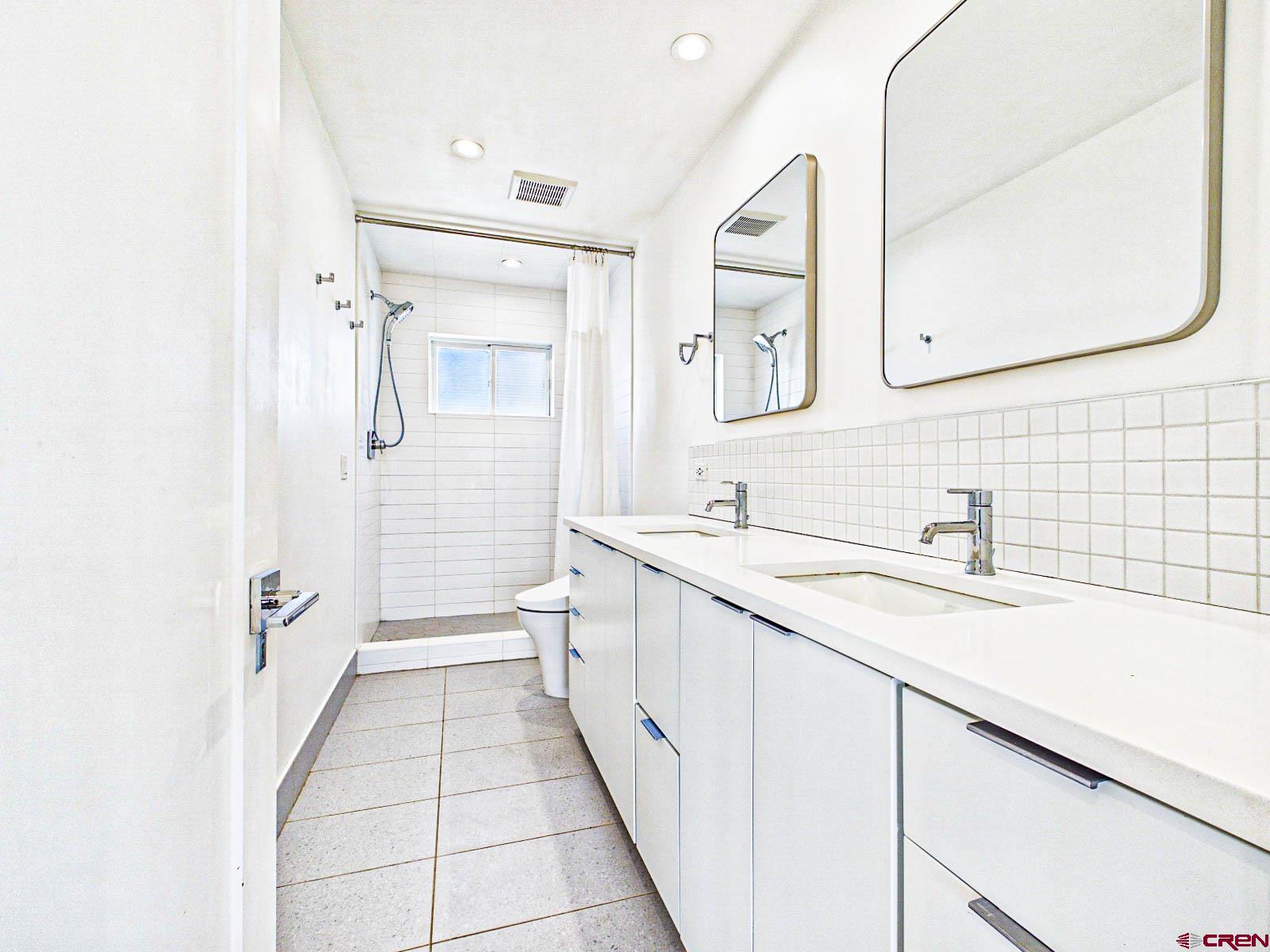 3530 Black Canyon Road Crawford, CO 81415 - Photo 19 of 45 a spacious bathroom with a double vanity sink mirror and