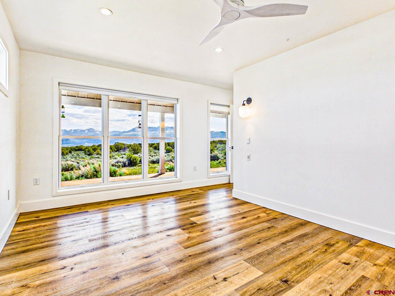 3530 Black Canyon Road Crawford, CO 81415 - Photo 22 of 45 a view of an empty room with wooden floor and a window