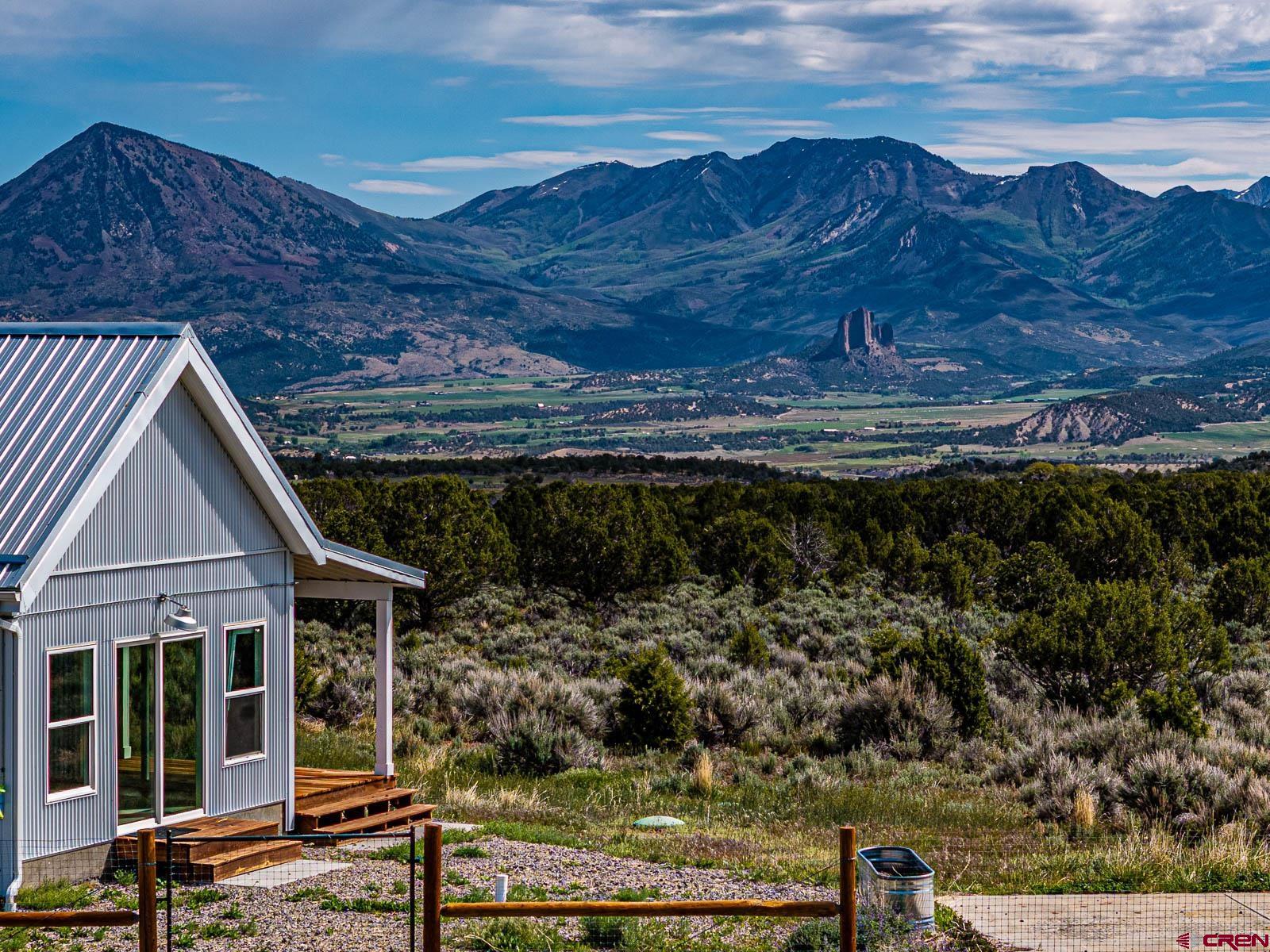 3530 Black Canyon Road Crawford, CO 81415 - Photo 26 of 45 a view of a house with a yard and a wooden fence