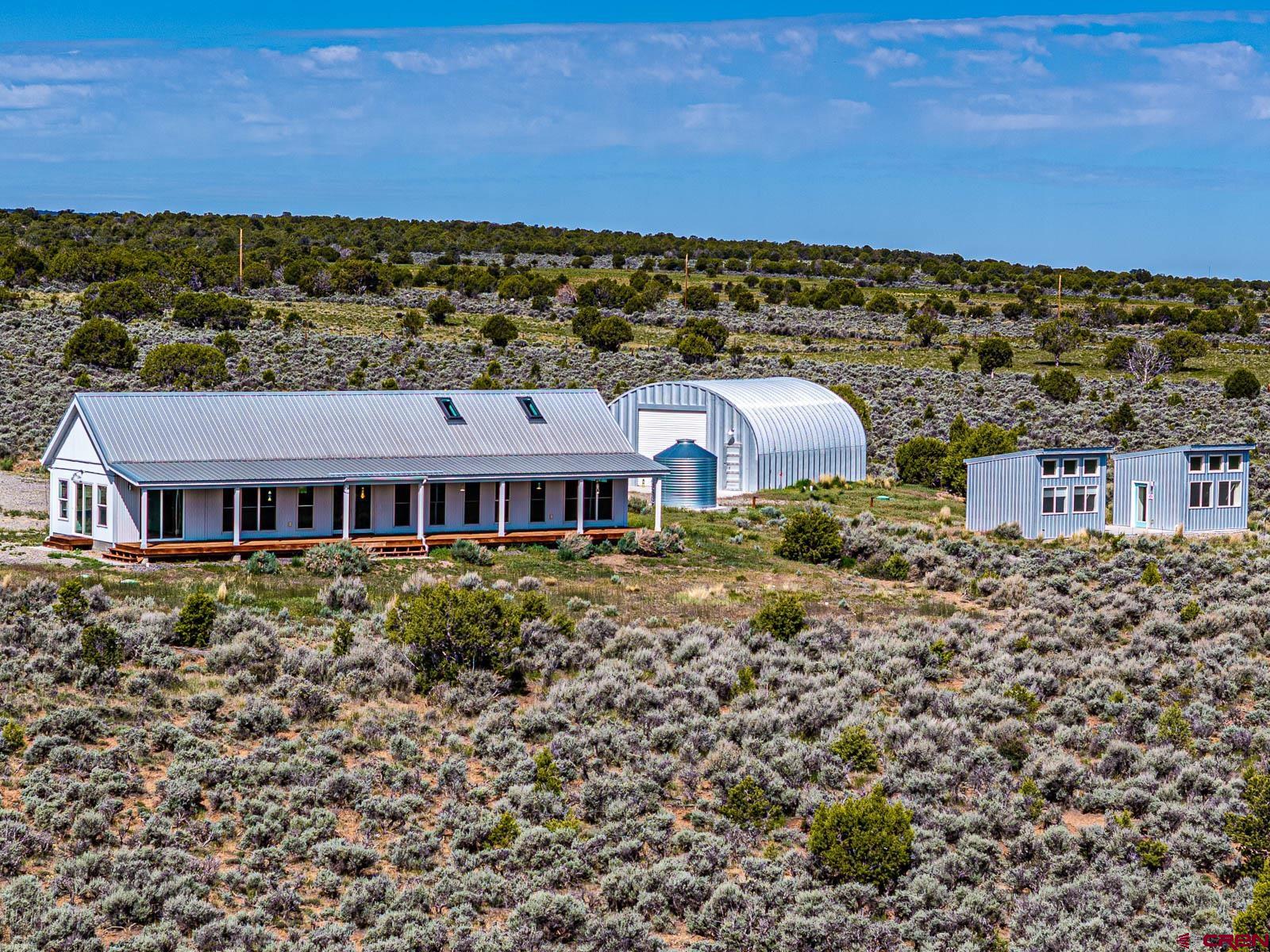 3530 Black Canyon Road Crawford, CO 81415 - Photo 28 of 45 a view of a big house with a big yard and large trees