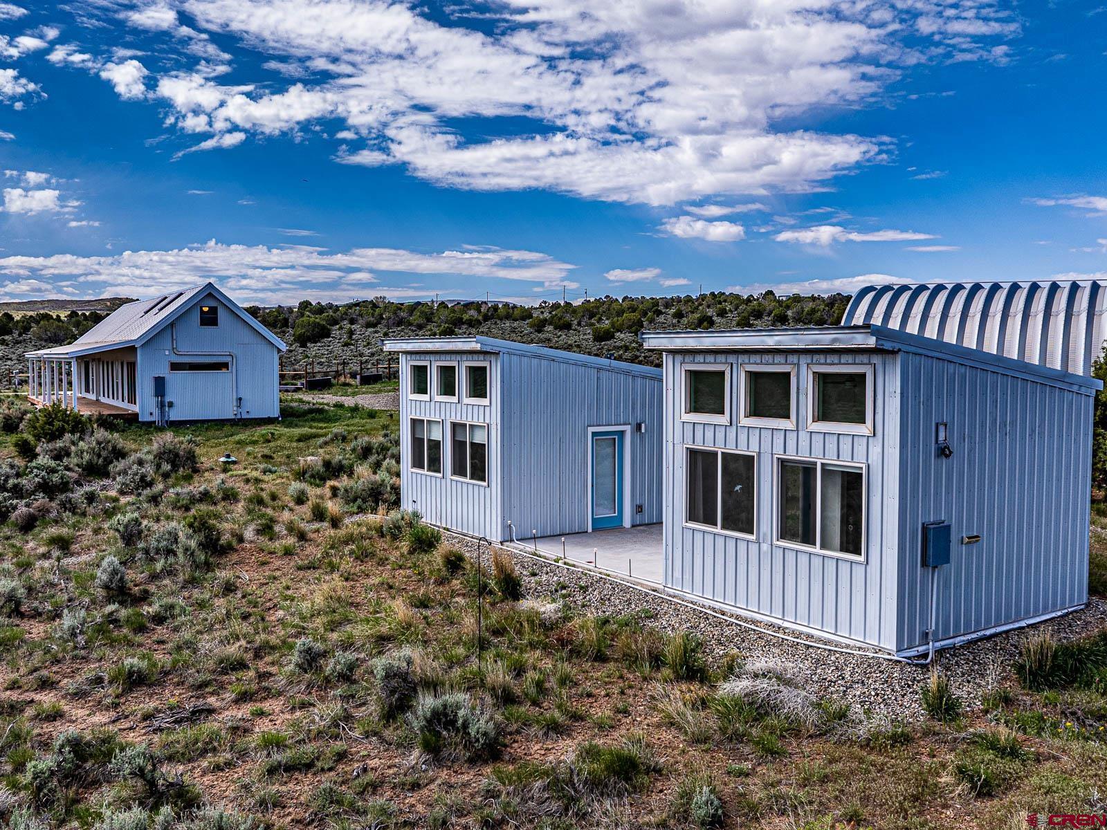 3530 Black Canyon Road Crawford, CO 81415 - Photo 32 of 45 a view of a house with a yard