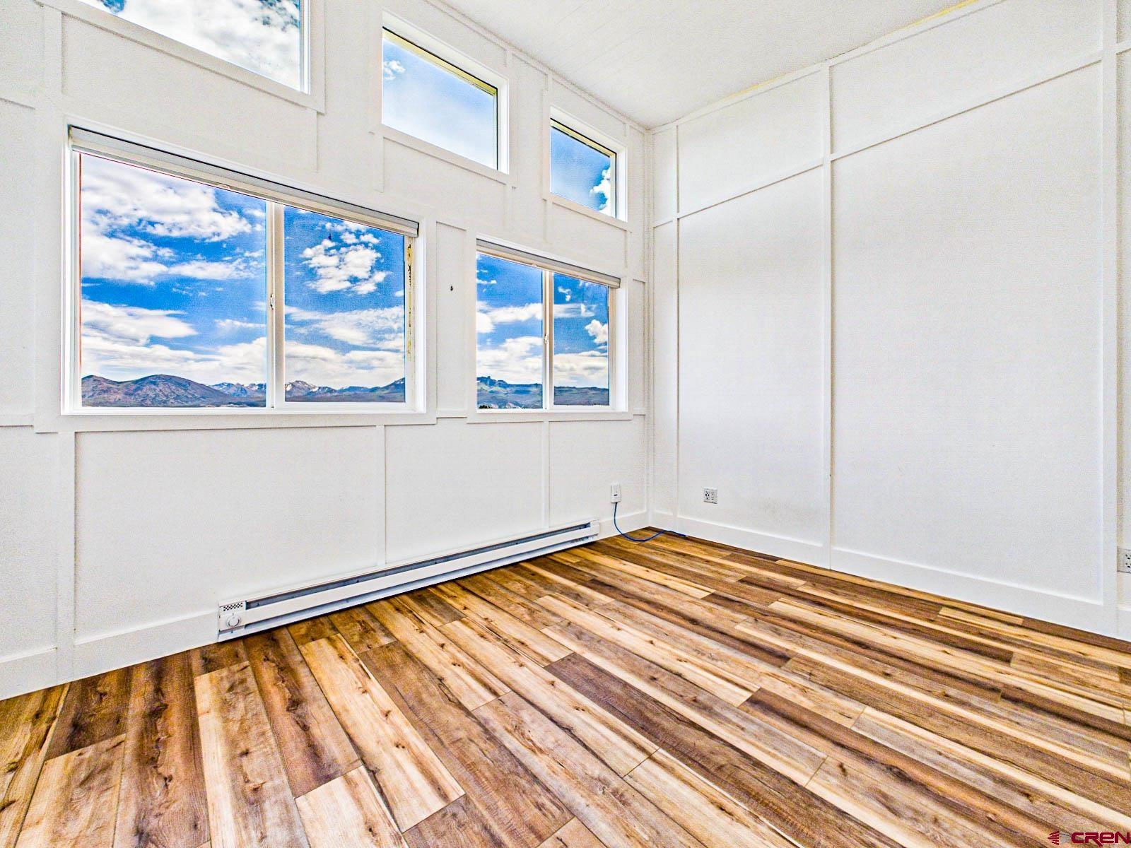 3530 Black Canyon Road Crawford, CO 81415 - Photo 34 of 45 a view of an empty room with a window and hardwood floor