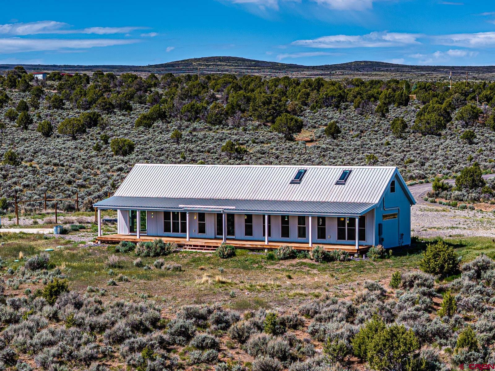 3530 Black Canyon Road Crawford, CO 81415 - Photo 6 of 45 a front view of a house with a yard