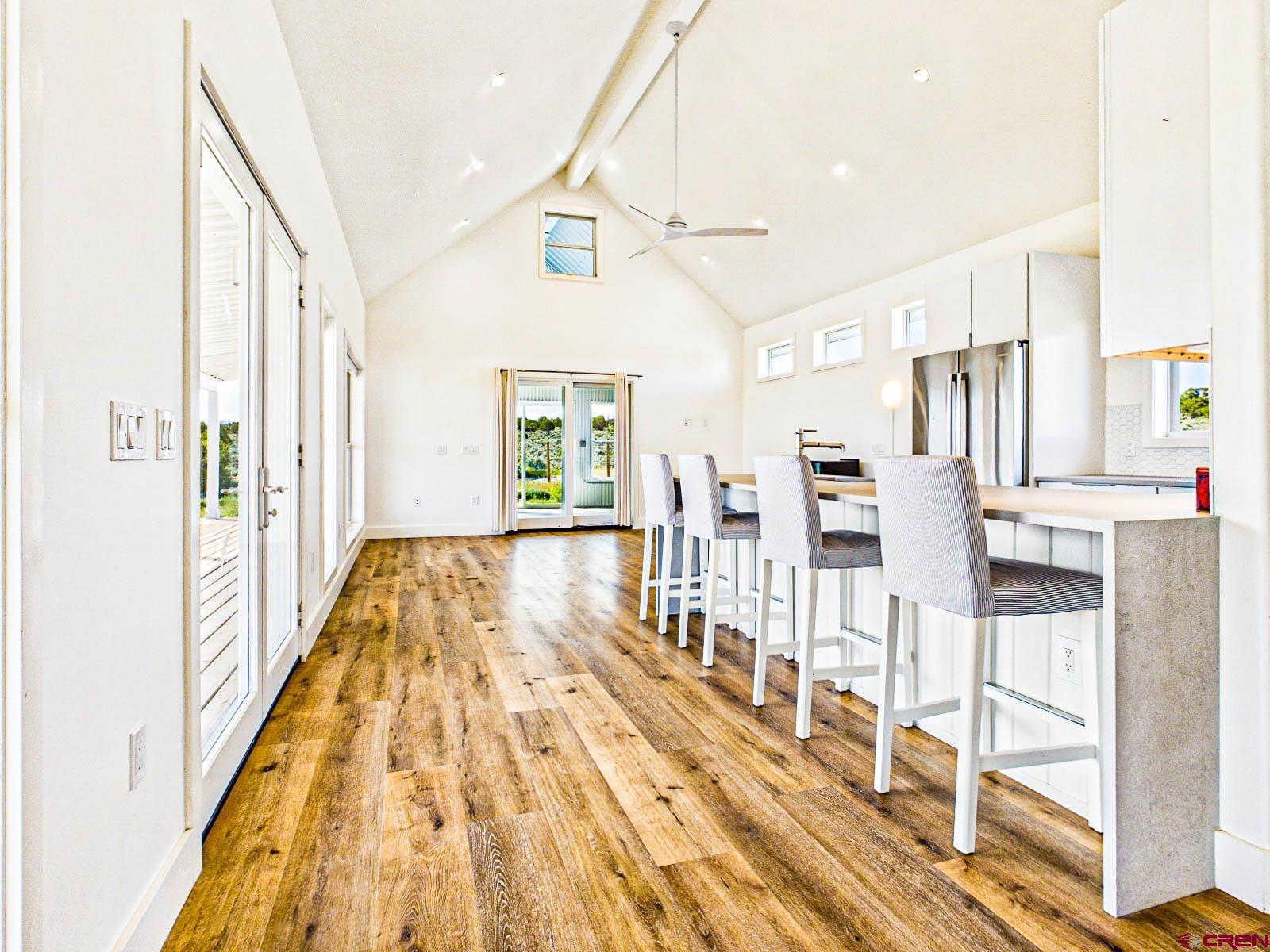 3530 Black Canyon Road Crawford, CO 81415 - Photo 10 of 45 a view of dining room with wooden floor and windows