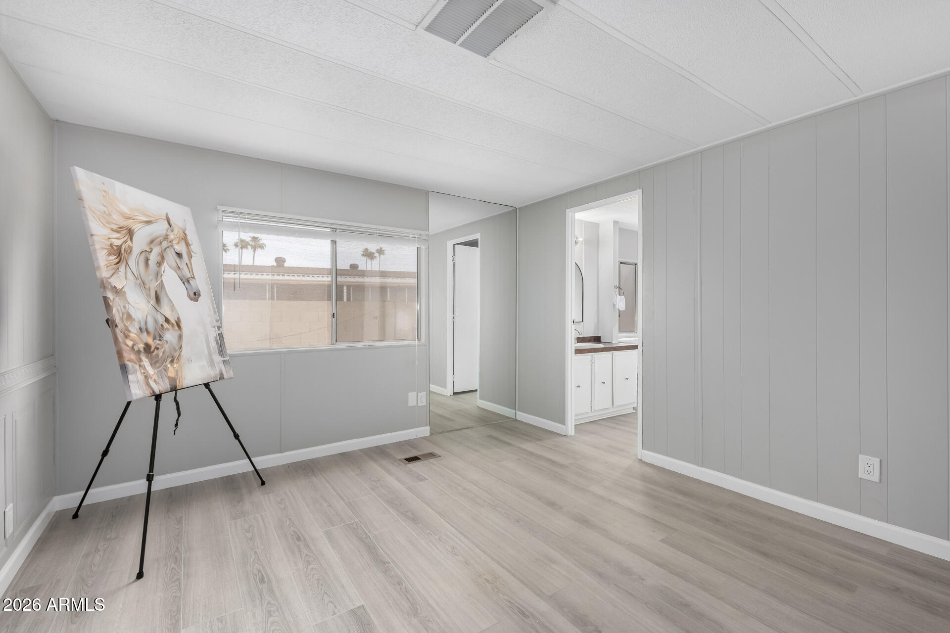 3104 East Broadway Road, Unit 30 Mesa, AZ 85204 - Photo 14 of 28 wooden floor in an empty room with a window