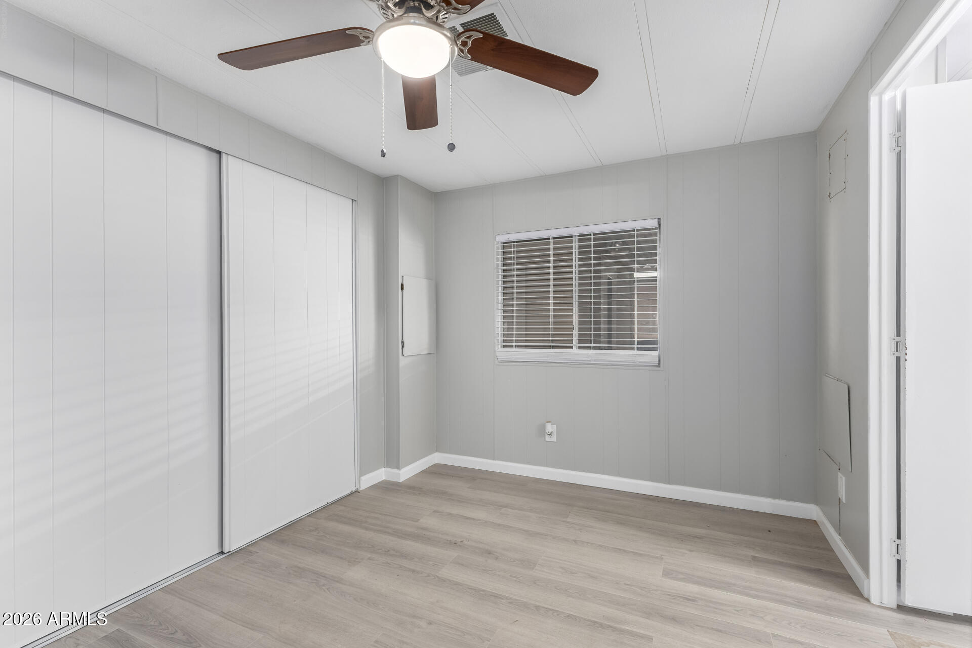 3104 East Broadway Road, Unit 30 Mesa, AZ 85204 - Photo 17 of 28 an empty room with a window and a ceiling fan