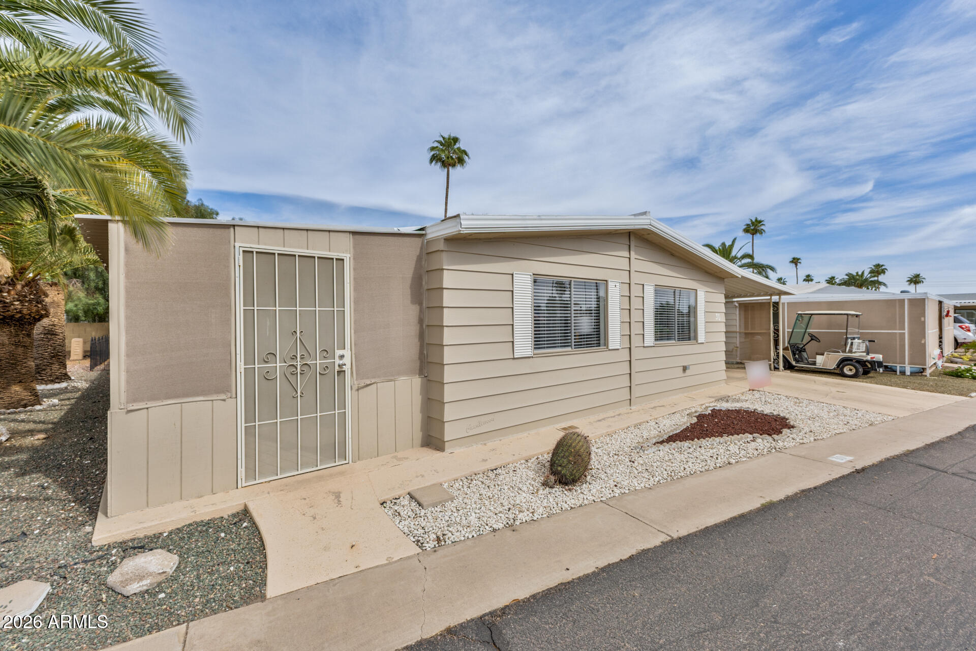 3104 East Broadway Road, Unit 30 Mesa, AZ 85204 - Photo 2 of 28 a front view of a house with a yard