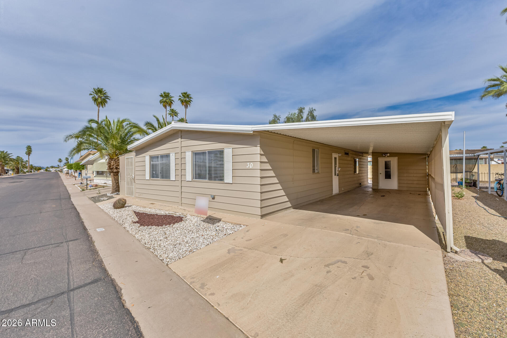 3104 East Broadway Road, Unit 30 Mesa, AZ 85204 - Photo 3 of 28 a front view of a house with a yard