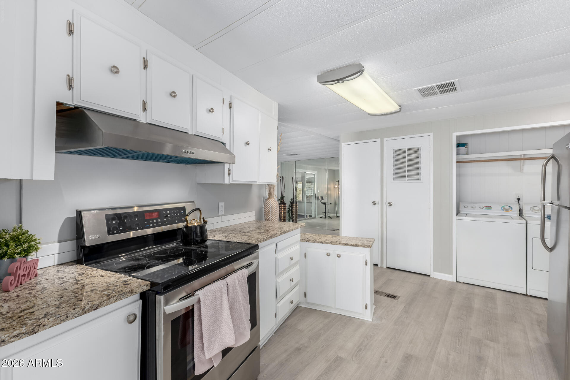 3104 East Broadway Road, Unit 30 Mesa, AZ 85204 - Photo 10 of 28 a kitchen with a sink stove and cabinets