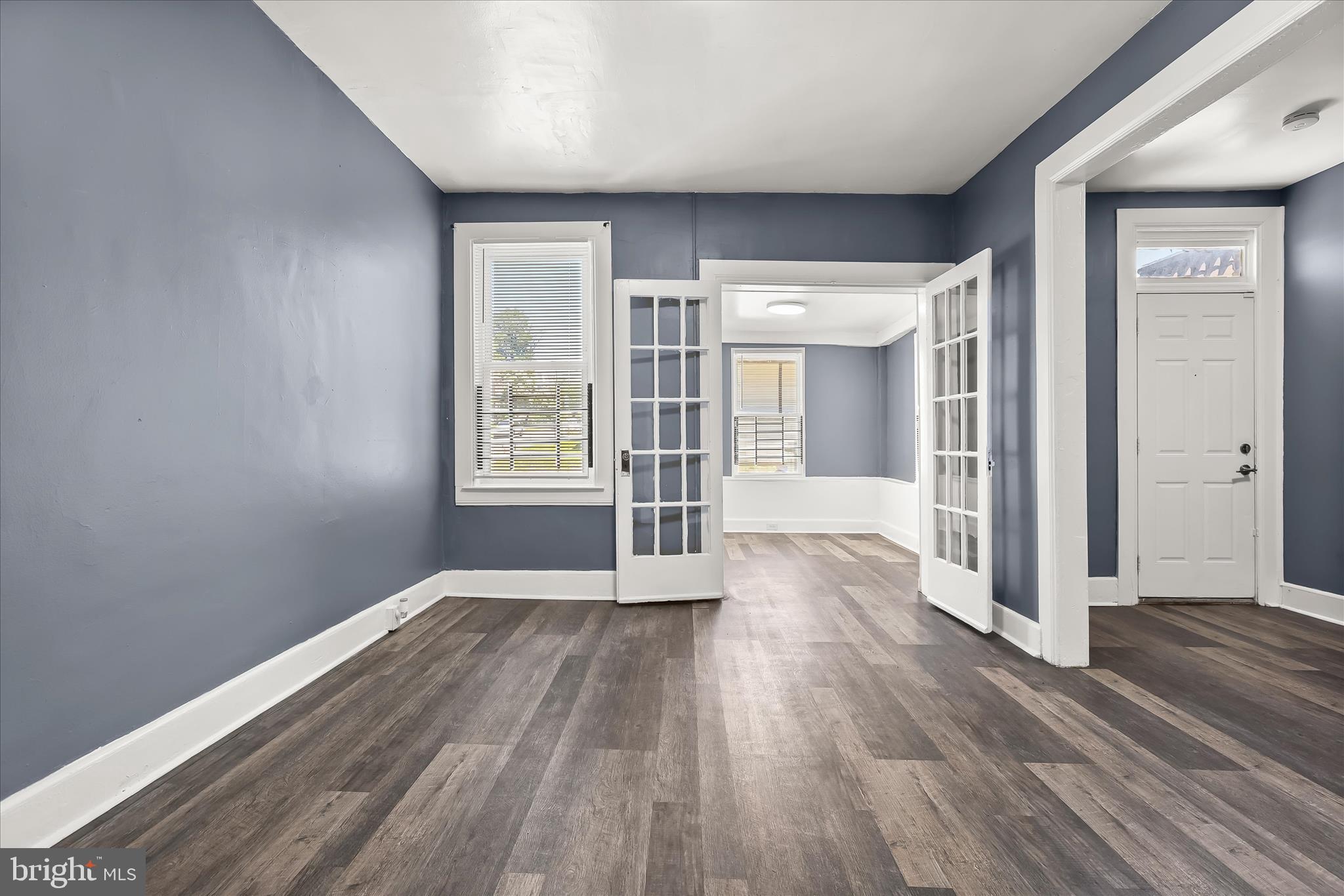 3534 Overview Road Baltimore, MD 21215 - Photo 6 of 28 an empty room with wooden floor and windows
