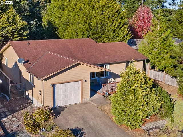 a aerial view of a house with a yard and garden
