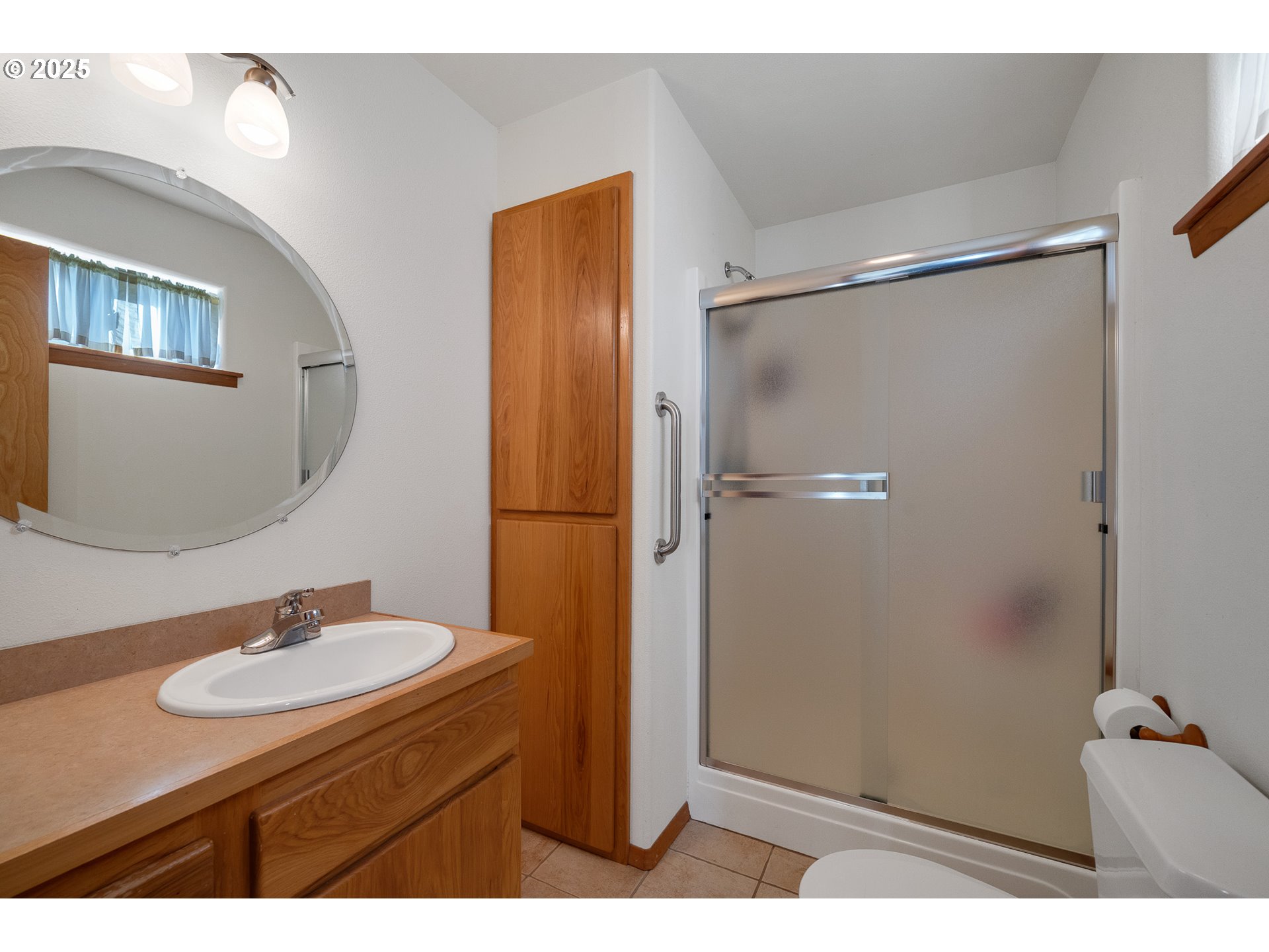 10750 Neptune Way Nehalem, OR 97131 - Photo 13 of 25 a bathroom with a sink mirror vanity and a toilet