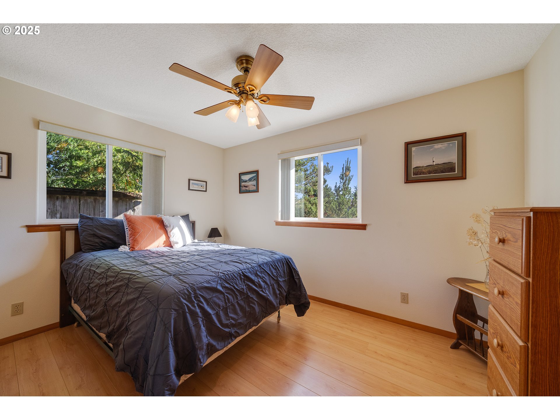 10750 Neptune Way Nehalem, OR 97131 - Photo 14 of 25 a bedroom with a bed and a window