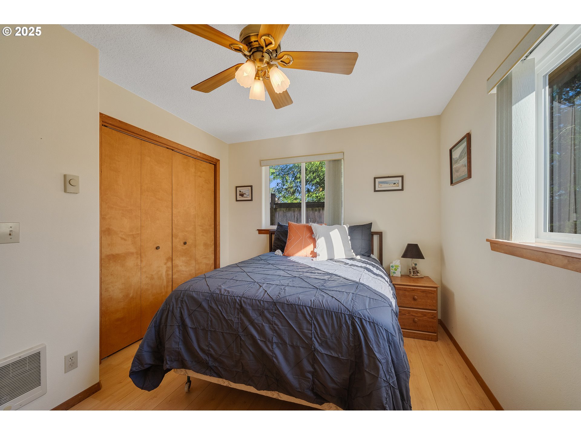 10750 Neptune Way Nehalem, OR 97131 - Photo 15 of 25 a bedroom with a bed and a chandelier