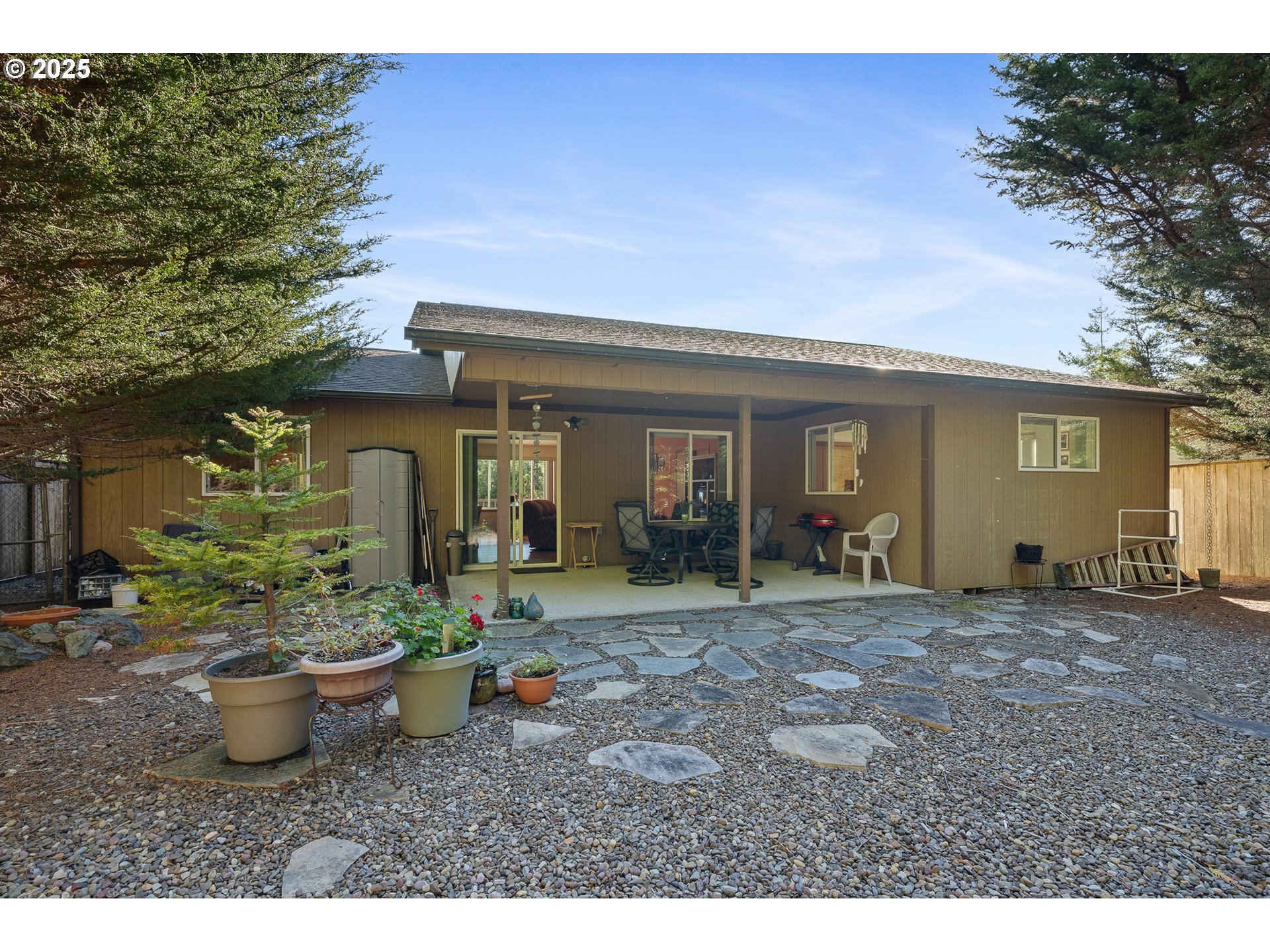 10750 Neptune Way Nehalem, OR 97131 - Photo 19 of 25 a view of a house with sitting area and garden