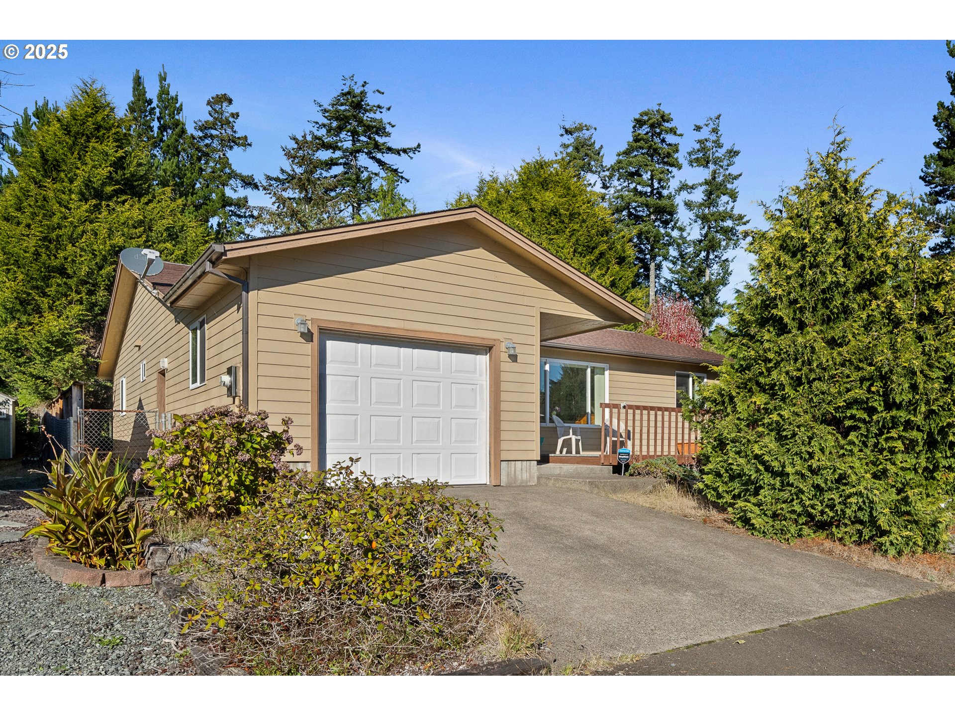 10750 Neptune Way Nehalem, OR 97131 - Photo 24 of 25 a view of a house with potted plants and a large tree