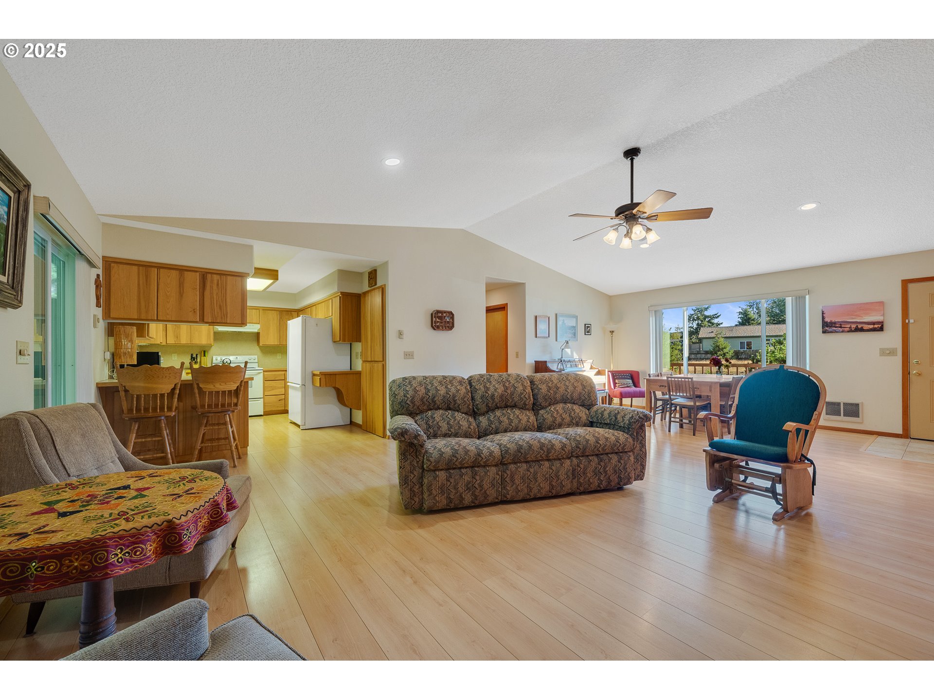 10750 Neptune Way Nehalem, OR 97131 - Photo 8 of 25 a living room with furniture and a dining table with wooden floor