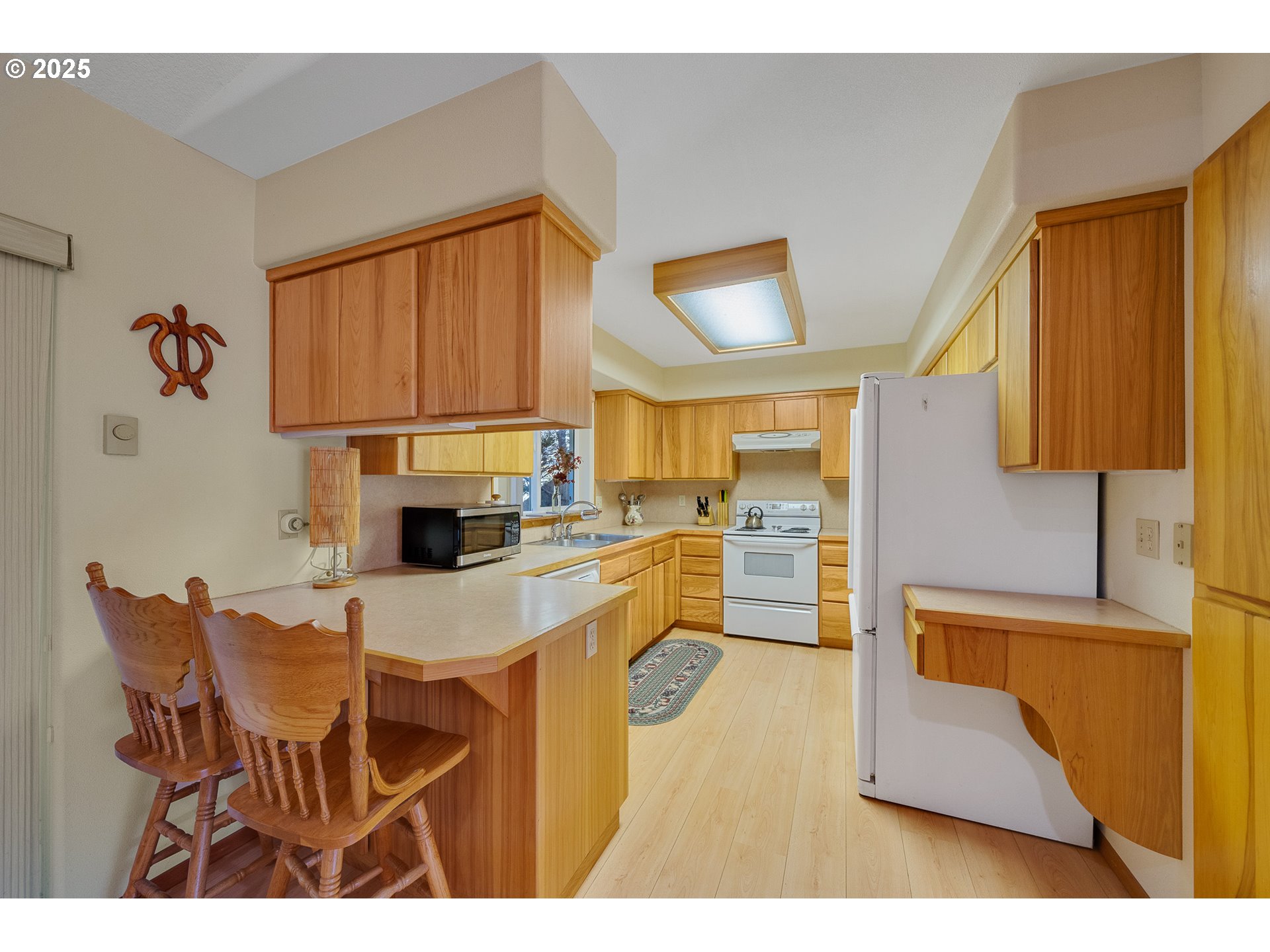 10750 Neptune Way Nehalem, OR 97131 - Photo 9 of 25 a kitchen with kitchen island a counter top space appliances and a cabinets