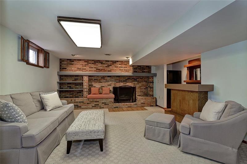 163 Glen Rape Road Rochester, PA 15074 - Photo 20 of 25 LOWER LEVEL: Family Rm w/ brick Fireplace & serving bar complete with water & frig.