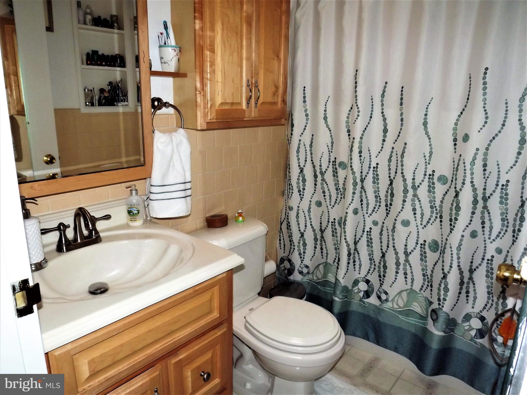 7357 Edsworth Road Baltimore, MD 21222 - Photo 23 of 30 Updated bathroom with oak cabinet.