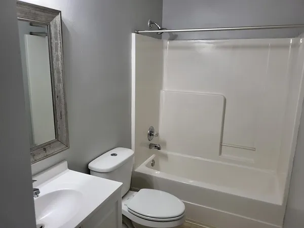 a bathroom with a toilet and a bathtub