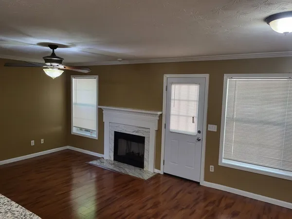 wooden floor fireplace and natural light in room