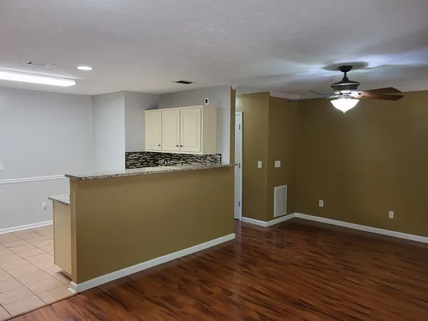 an empty room with wooden floor